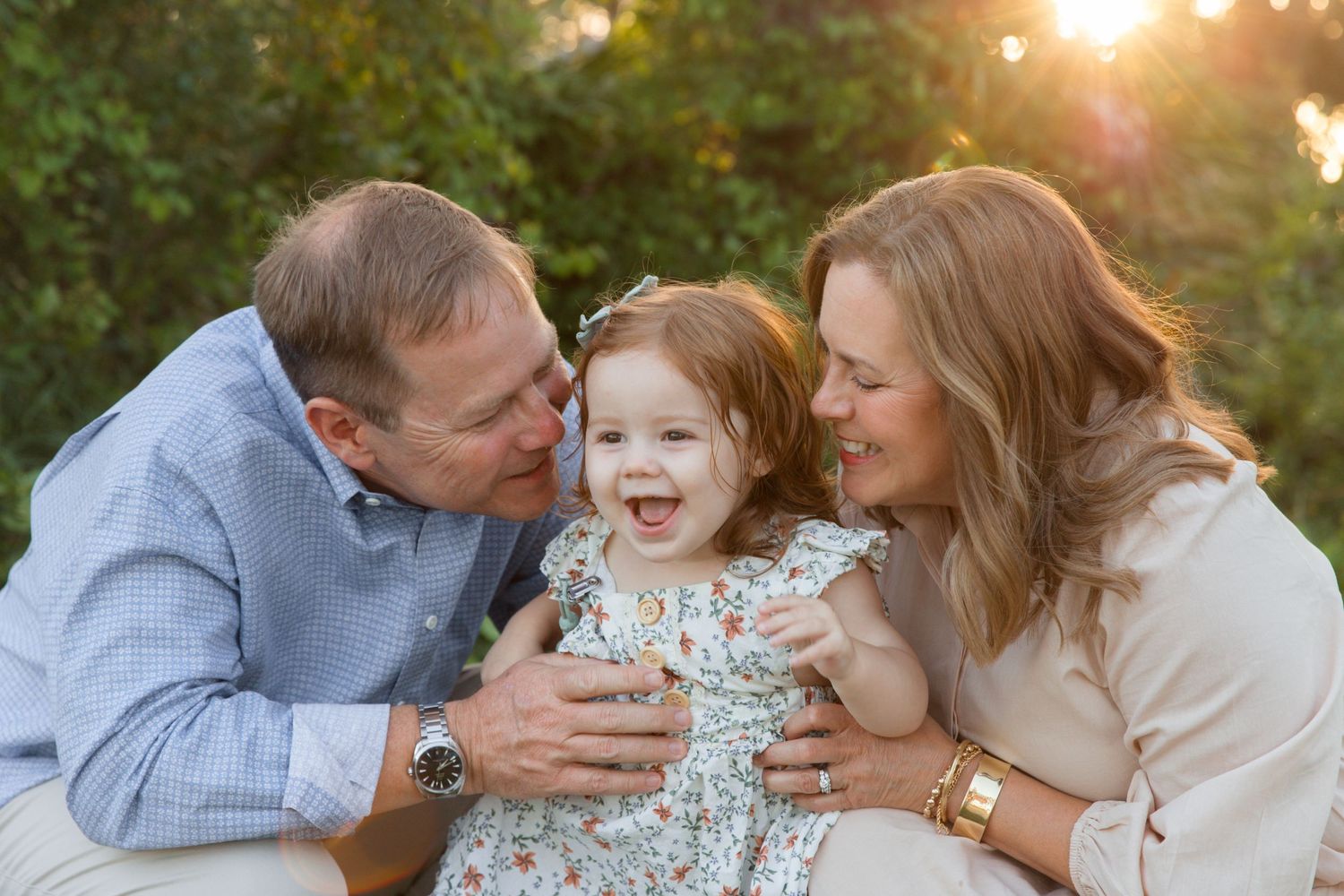 Family sharing tender moments together during golden hour sunset photoshoot.