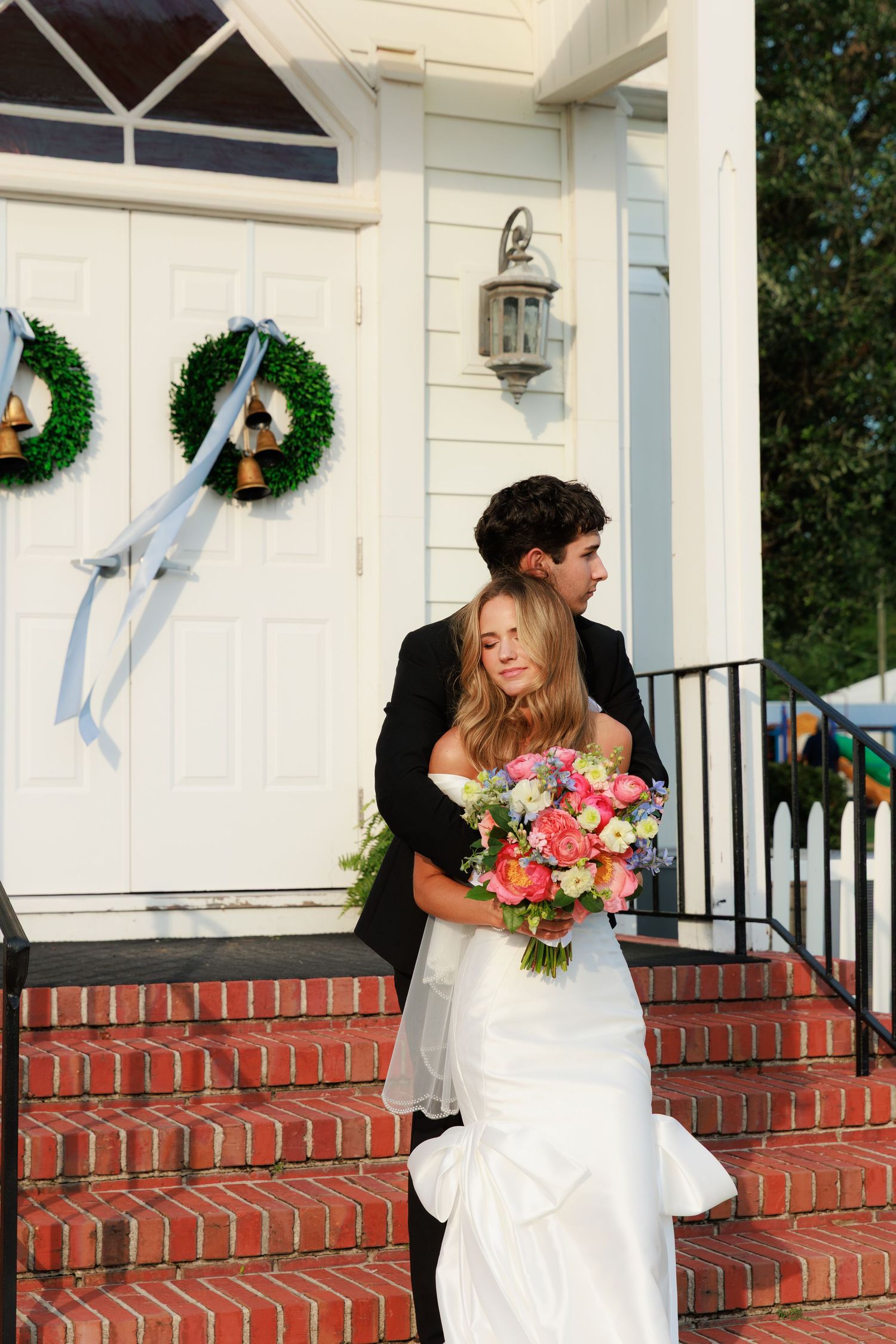 Wedding sequence showing a church entrance with wreaths and couple on brick steps with colorful floral bouquet.