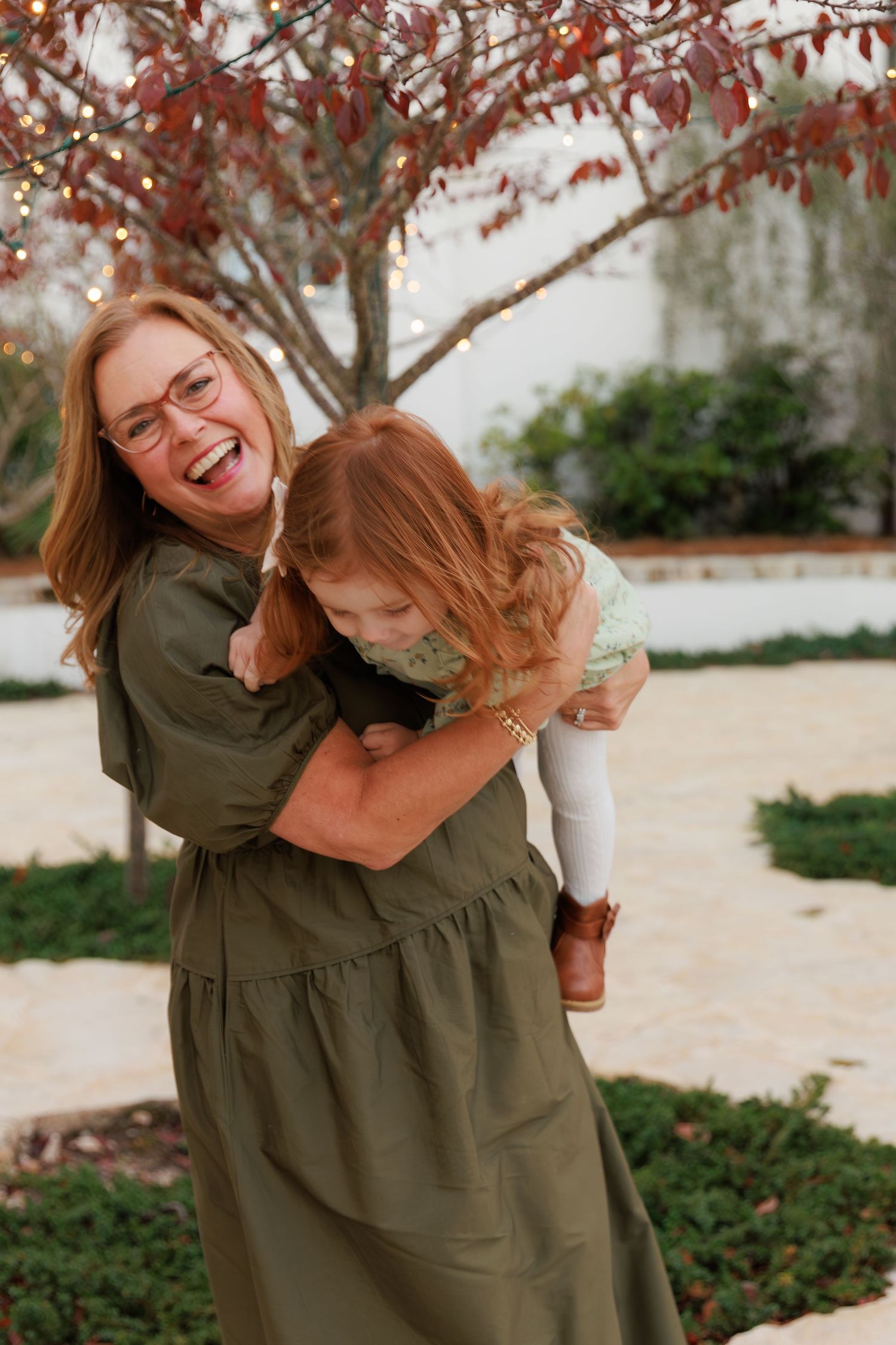Joyful candid moments shared between two people in outdoor setting with fall foliage.