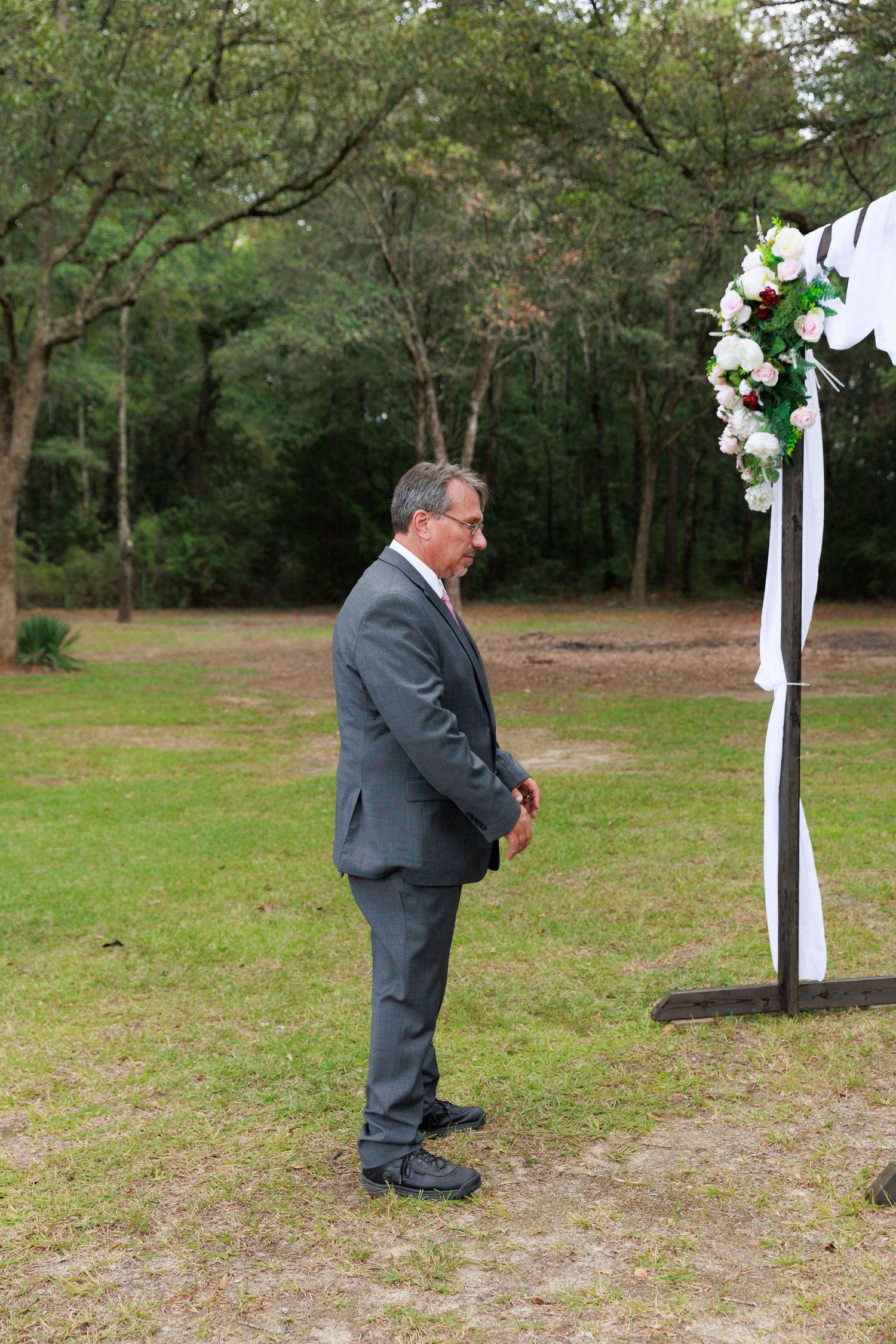 A series of candid wedding photos showing someone in a gray suit kneeling outdoors near decorative white posts.