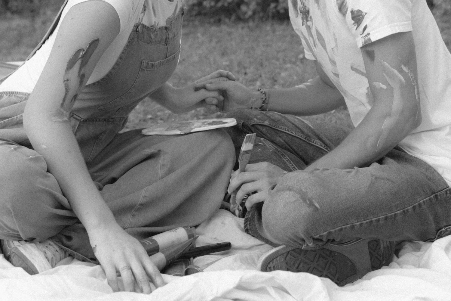 A sequence of black and white photographs showing hands working with clay on a pottery wheel.