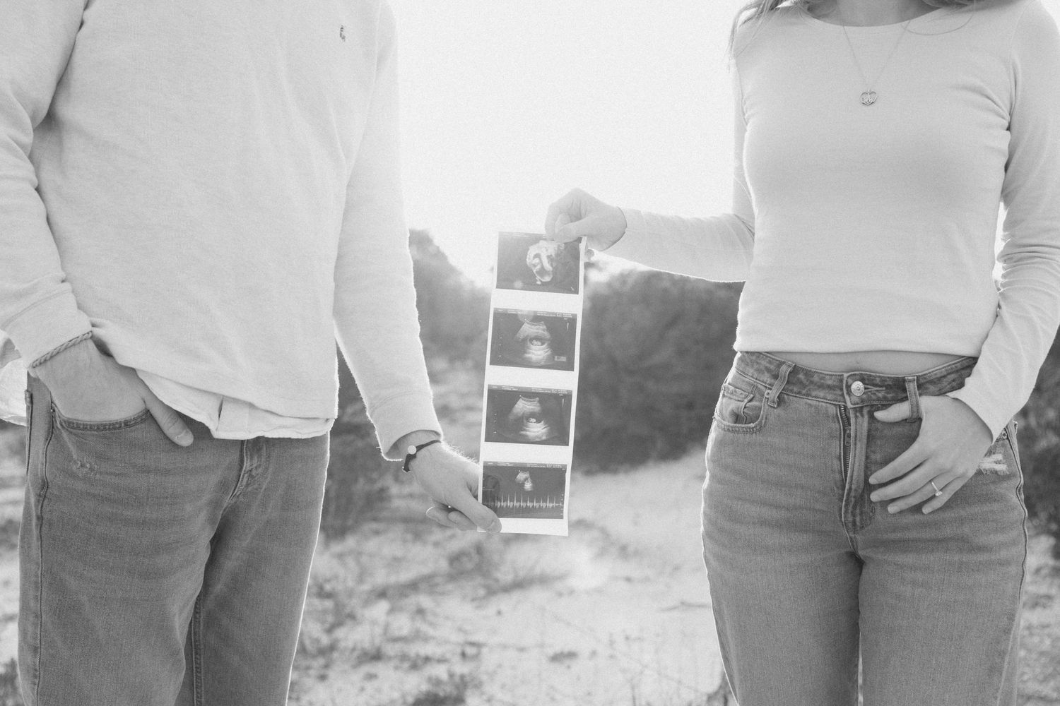A series of black and white maternity photos showing a pregnant woman's growing belly over time.