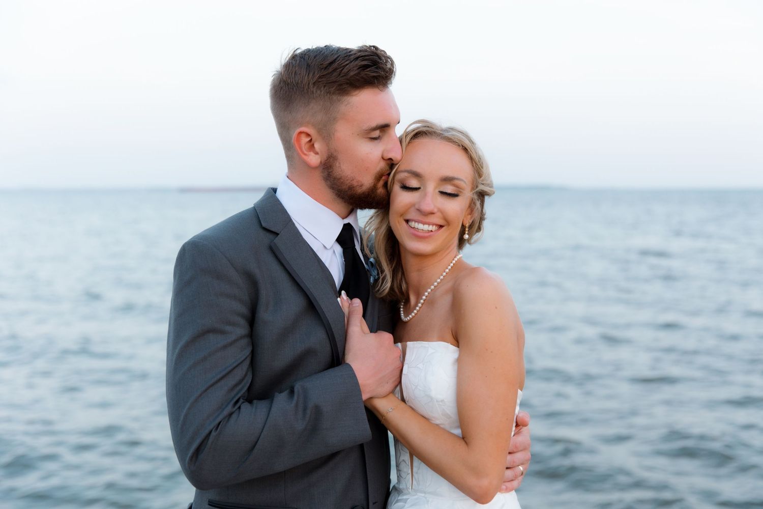 Intimate wedding photos captured against a serene ocean backdrop.