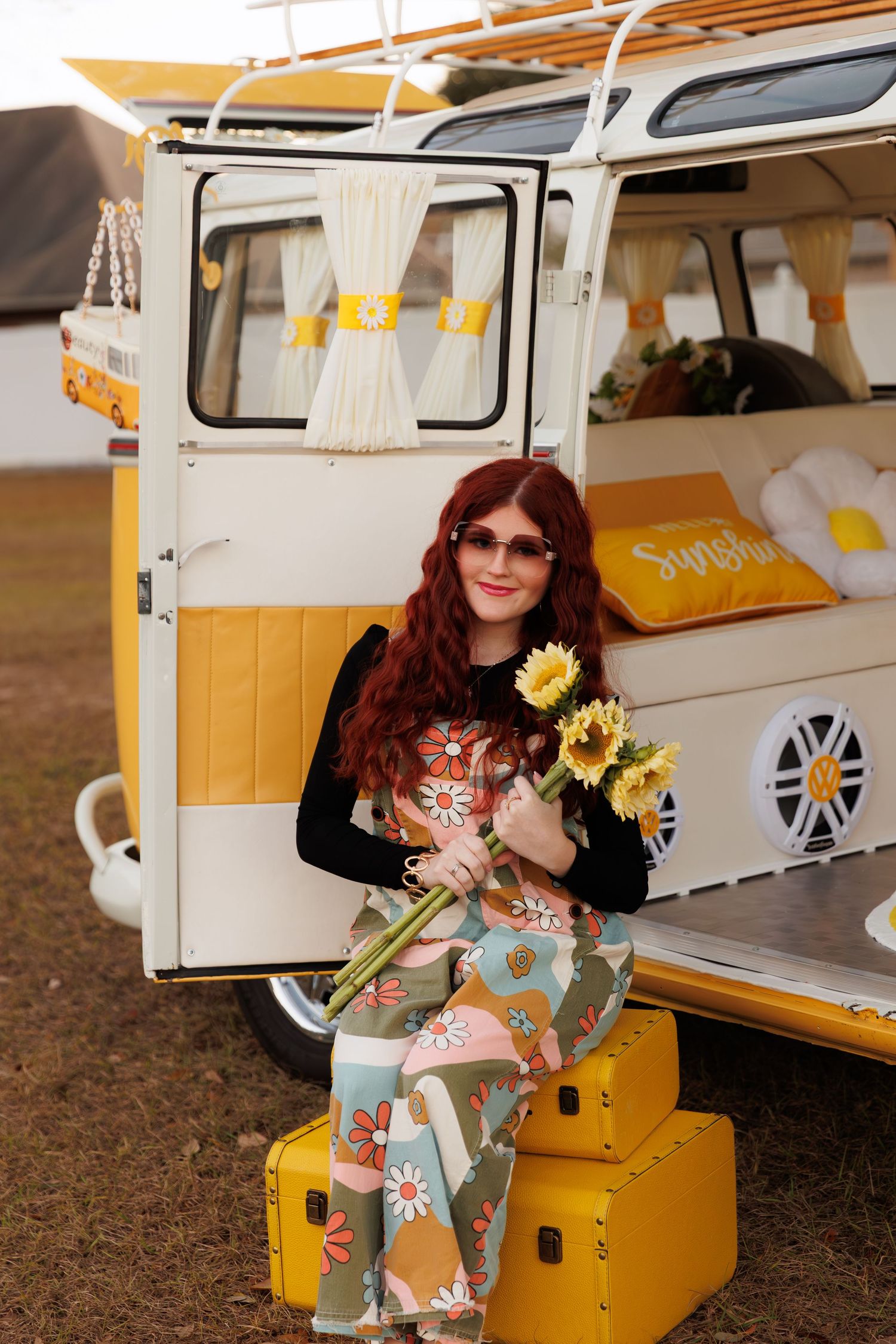 A stylized portrait session with a yellow vintage Volkswagen bus and sunflowers as props.