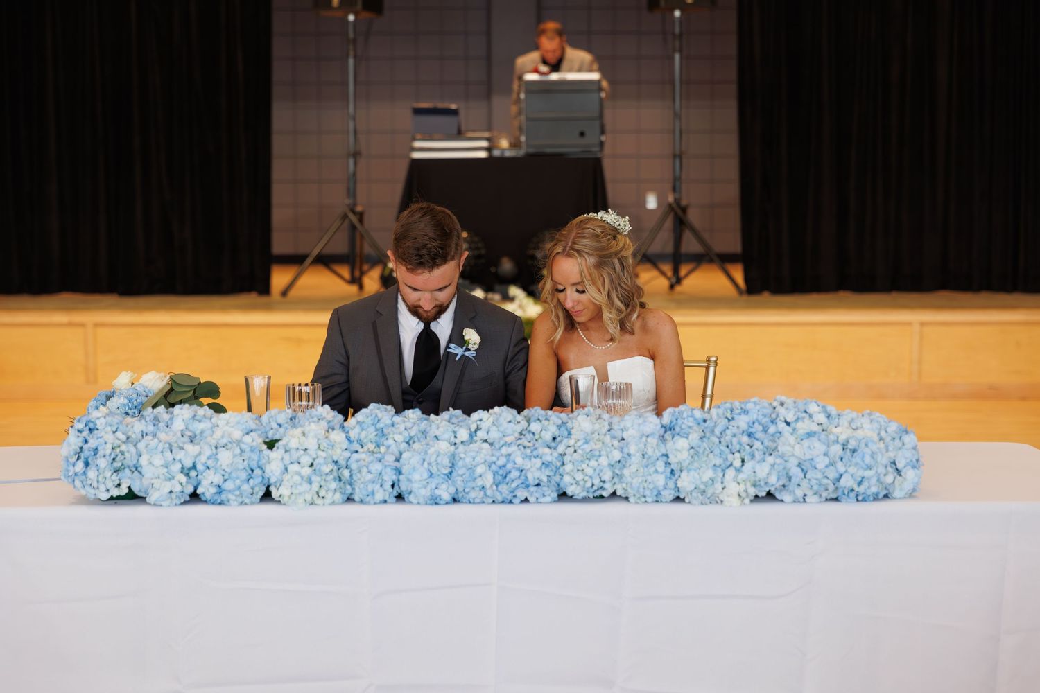Table decorated with blue hydrangeas at a wedding reception.