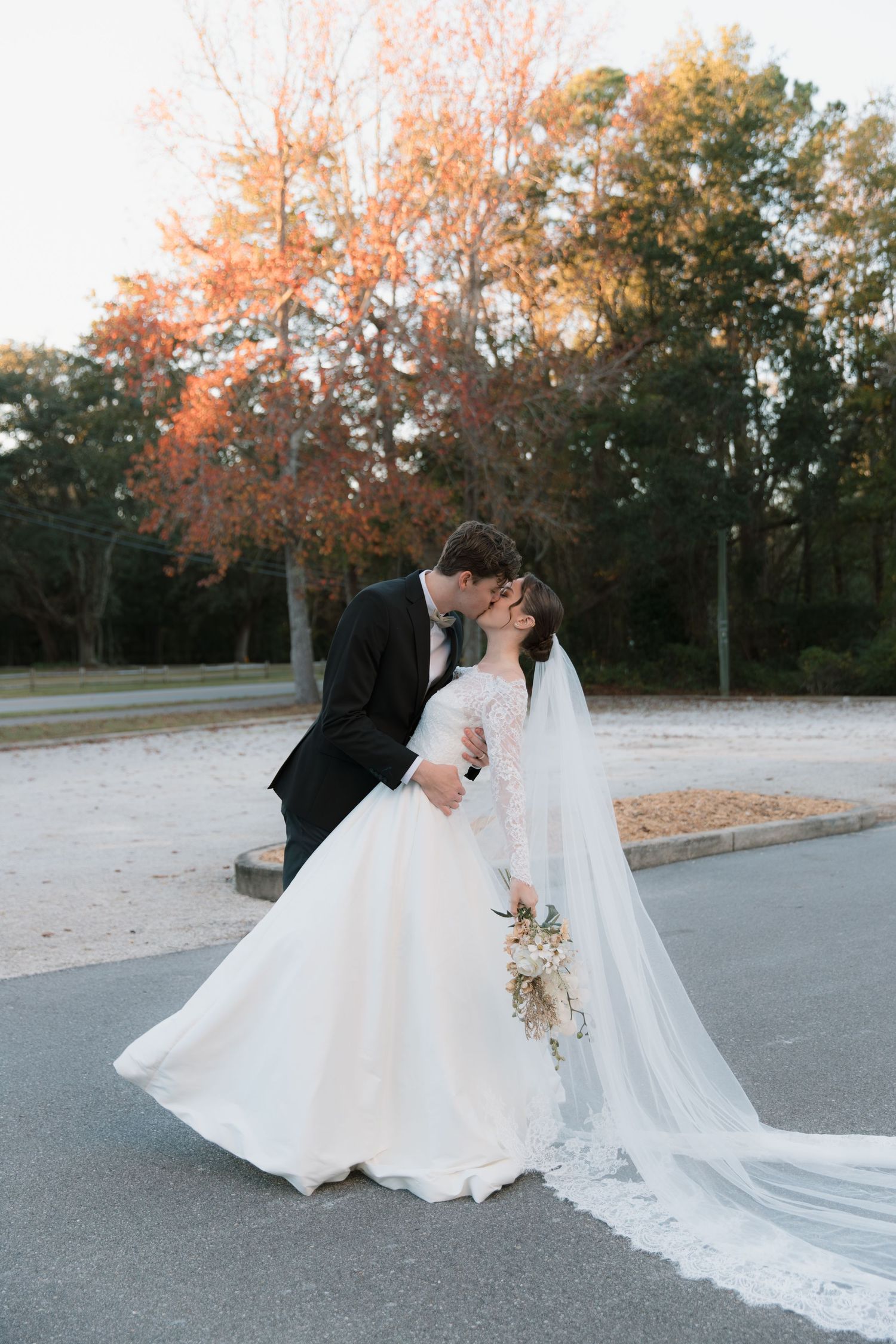 Romantic autumn wedding photos with golden sunset light and flowing white dress.