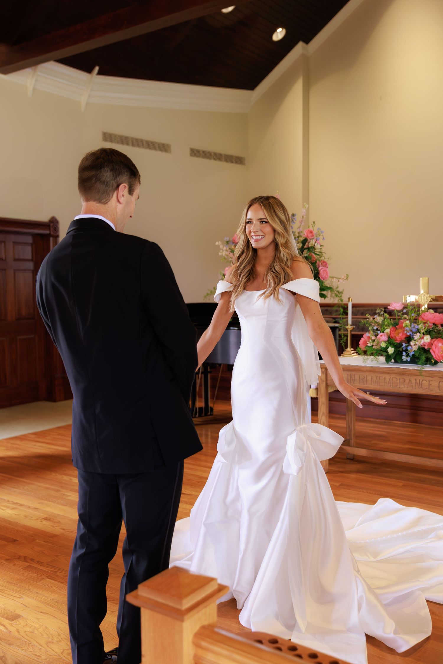 A sequence of four photos showing a couple dancing together in a ballroom with wooden floors and soft lighting.