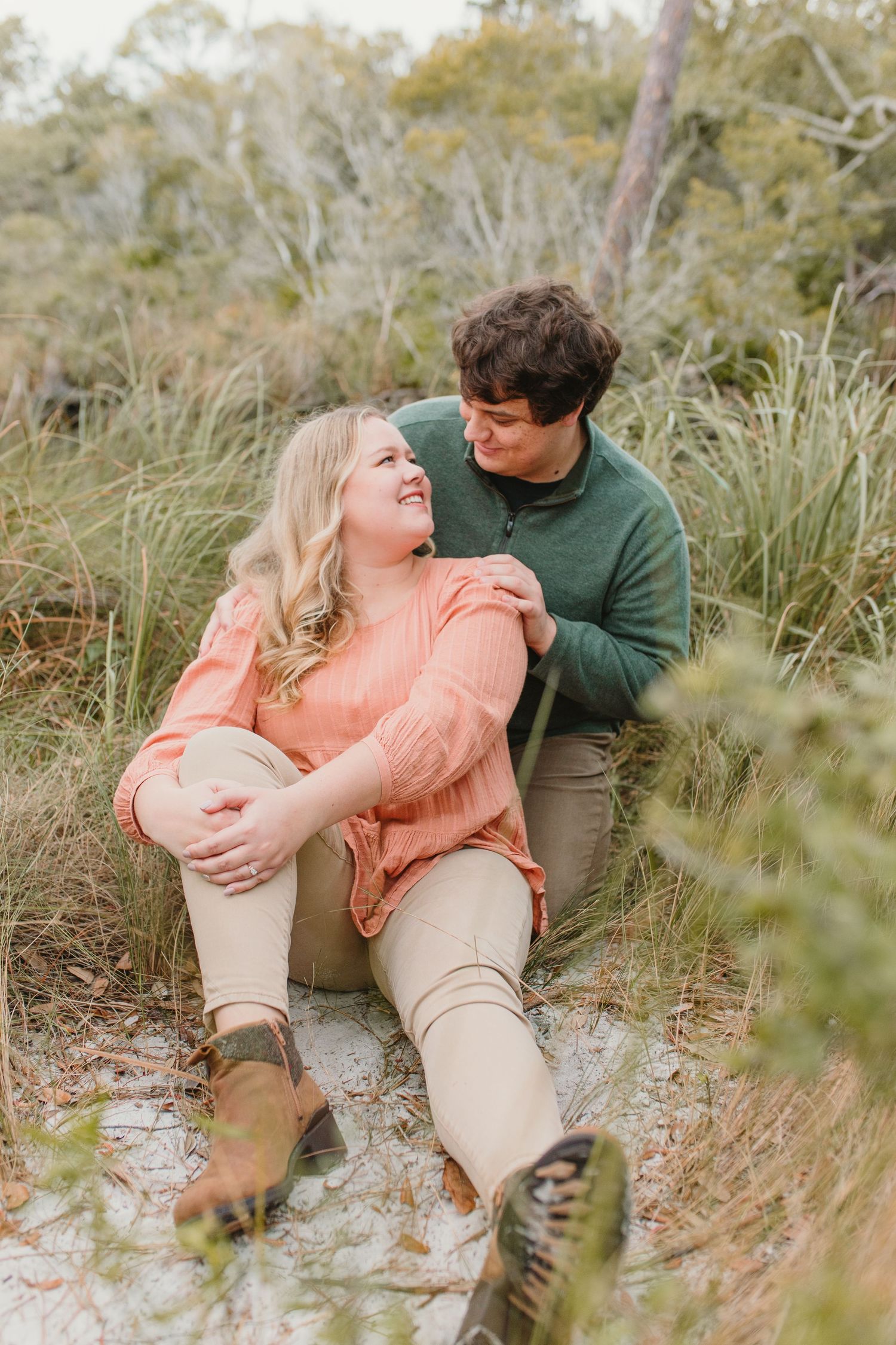 Couple enjoying romantic moment together while sitting in natural coastal setting.