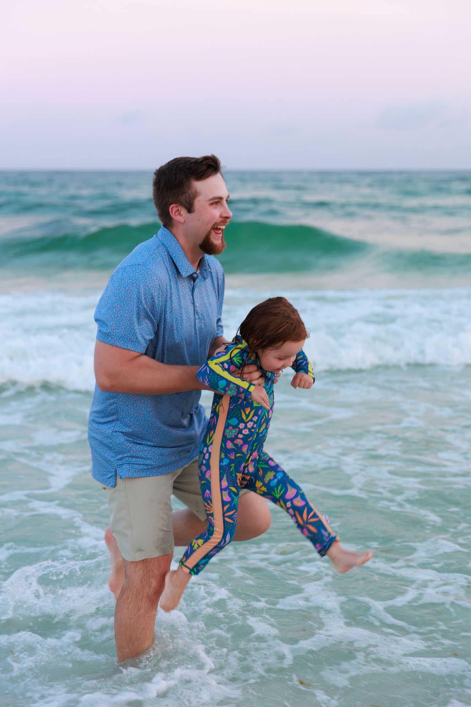 Playful moment captured at the beach as waves crash around people enjoying the ocean surf.