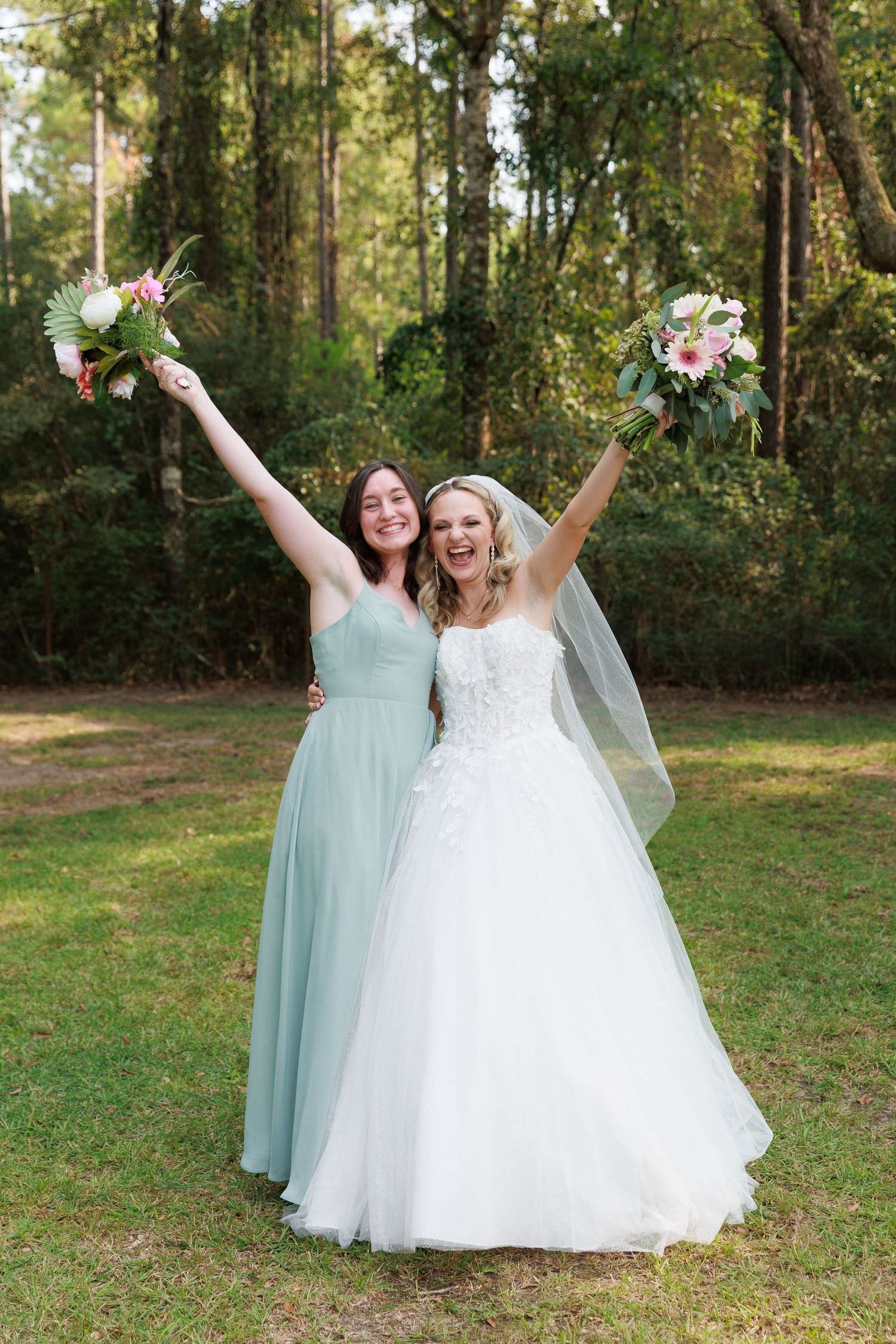 Wedding celebration captured in a series of joyful poses against a wooded backdrop with mint and white attire.