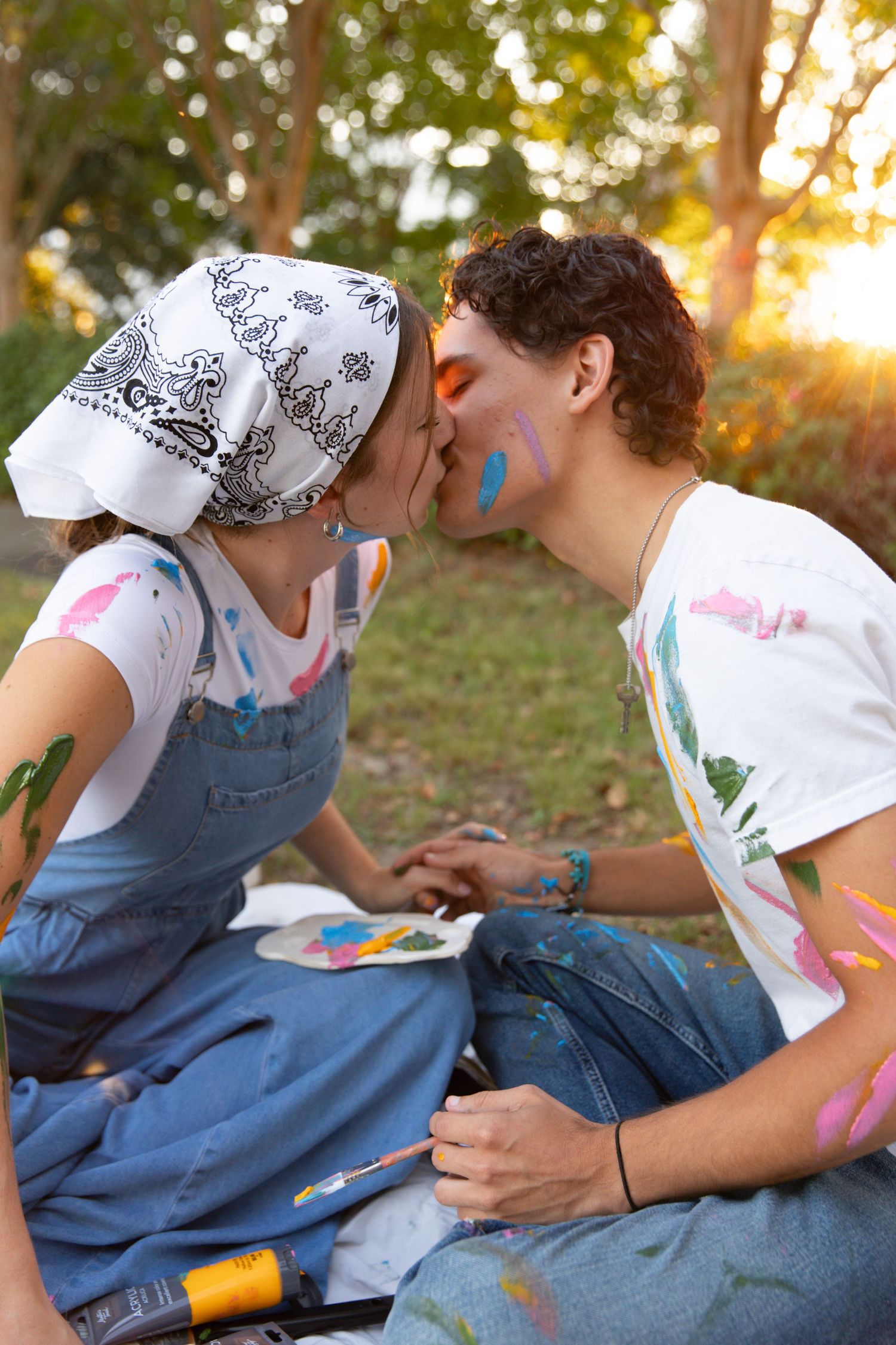 Two people in denim and white shirts share intimate moments at sunset in a series of romantic poses.