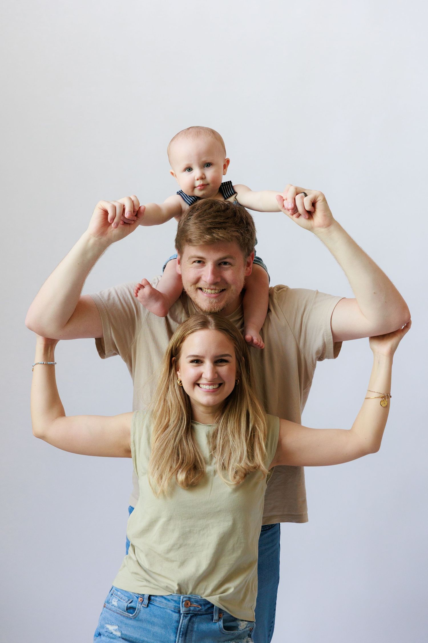 A series of lighthearted family portraits against a white background showing playful poses and interactions.
