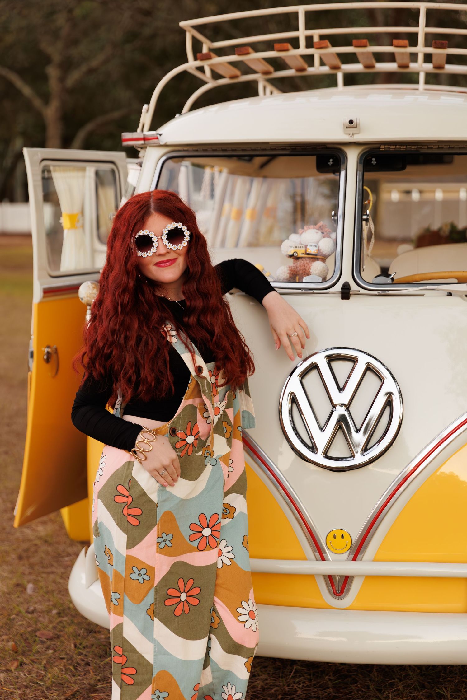 A vintage yellow and white Volkswagen bus serves as backdrop for a retro-styled photoshoot.