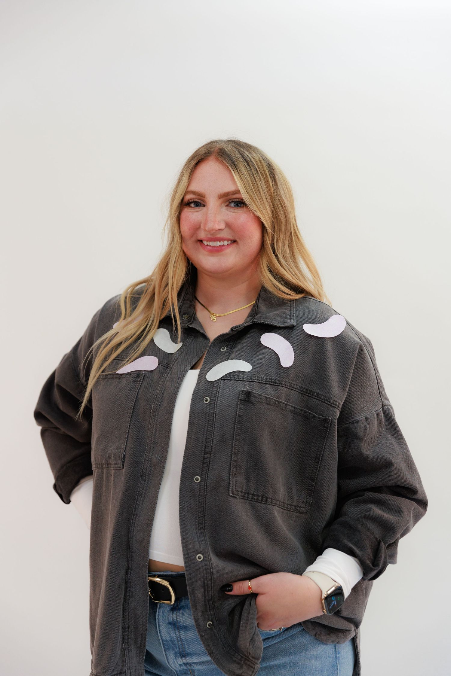 Modern casual outfit featuring gray denim jacket with white design elements.
