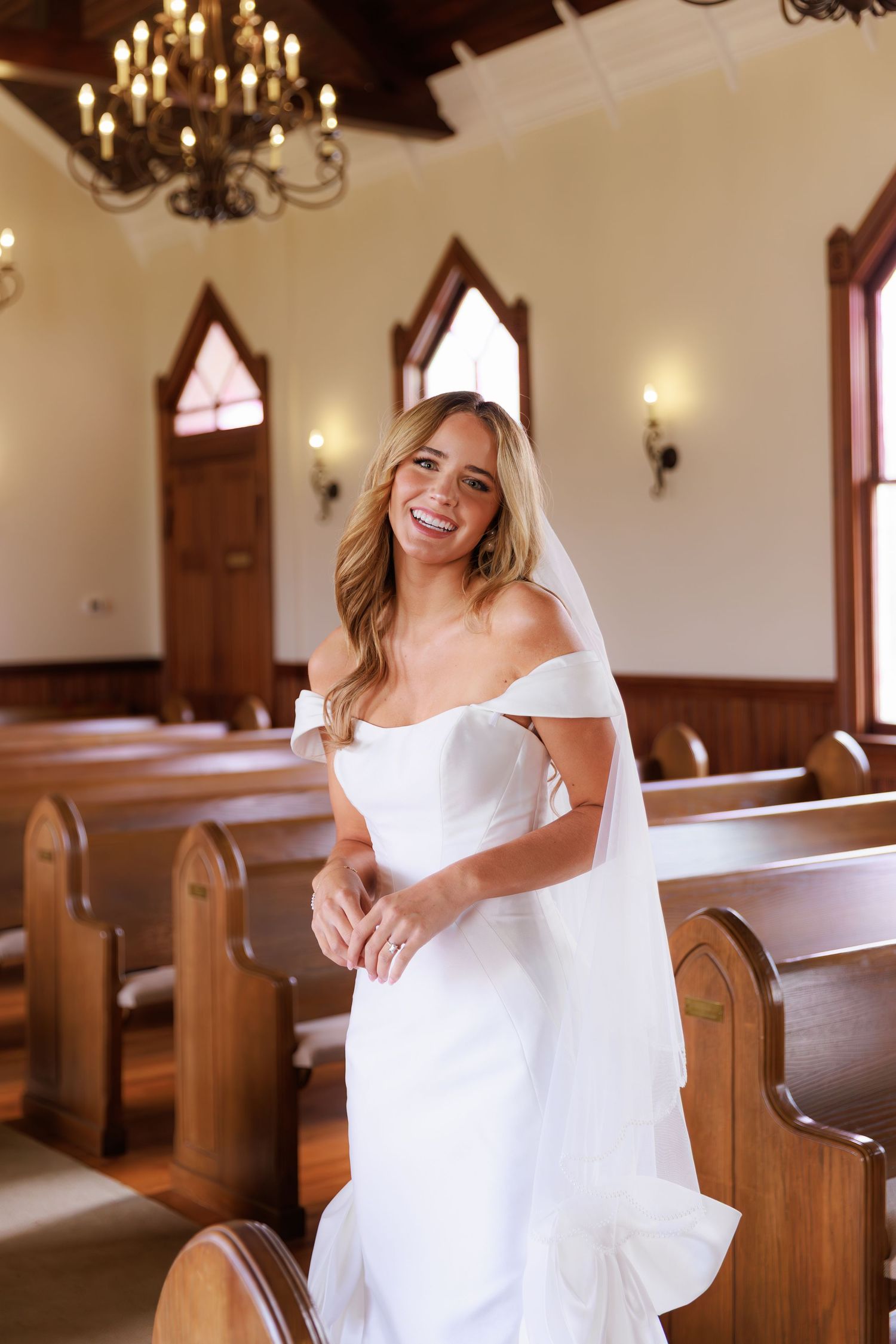 A bright and joyful moment captured in a church interior with wooden pews and warm lighting.