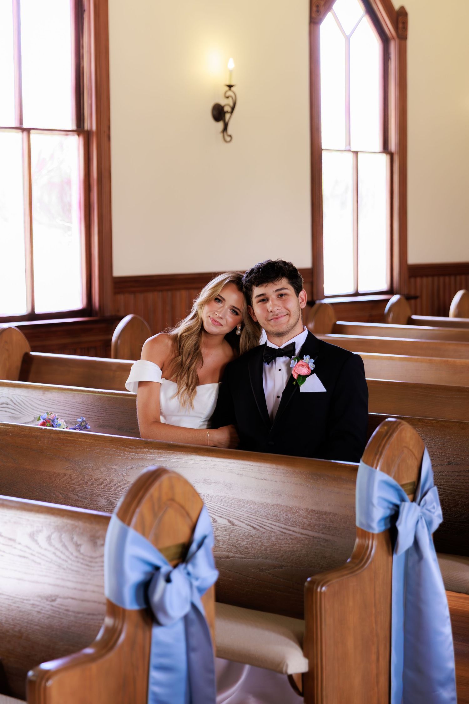 A series of wedding photos showing couple seated in wooden church pews decorated with light blue bows.