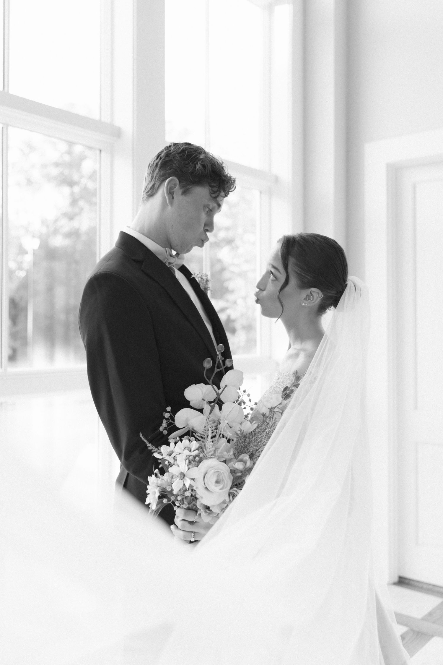 Elegant black and white wedding portraits in a bright indoor setting.