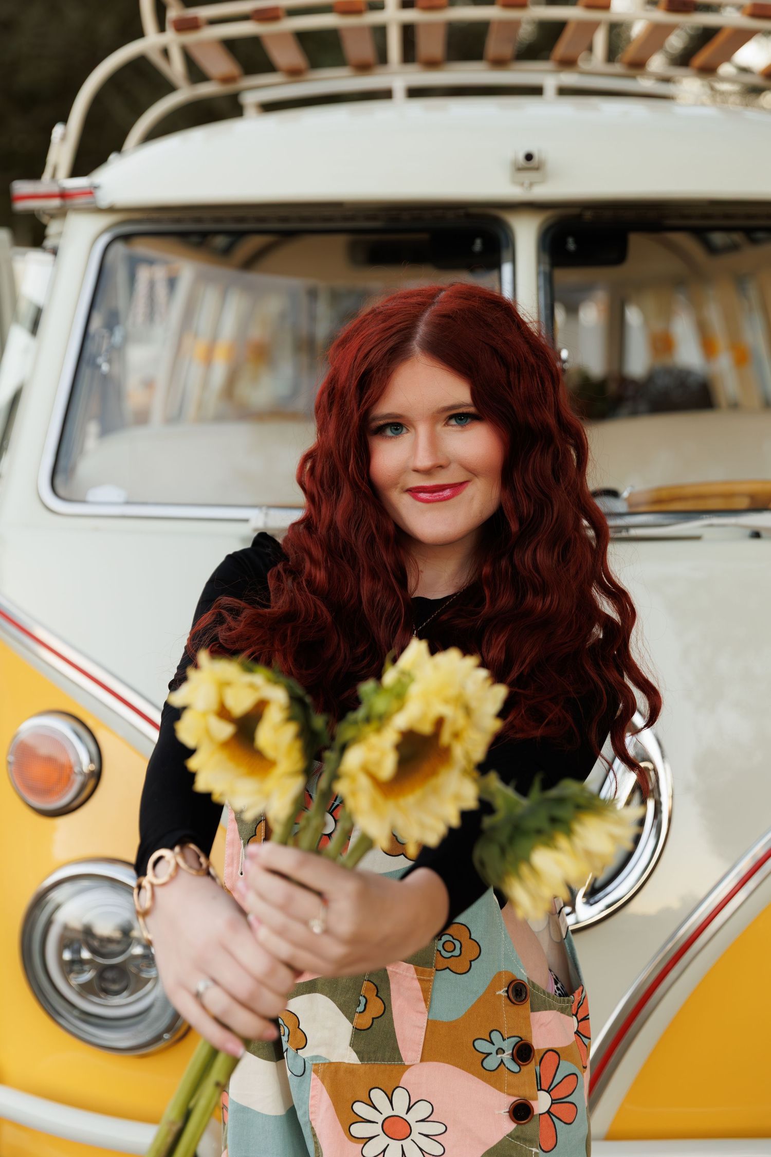 A vintage yellow and white van decorated with flowers and stickers creates a retro aesthetic.