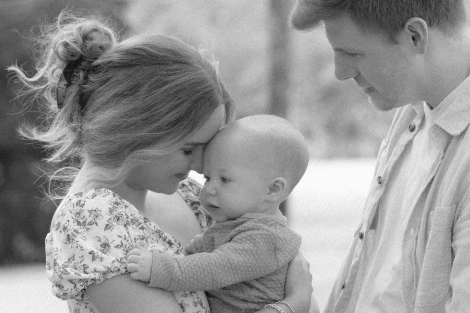 A series of black and white intimate family moments showing tender interactions between parents and children.