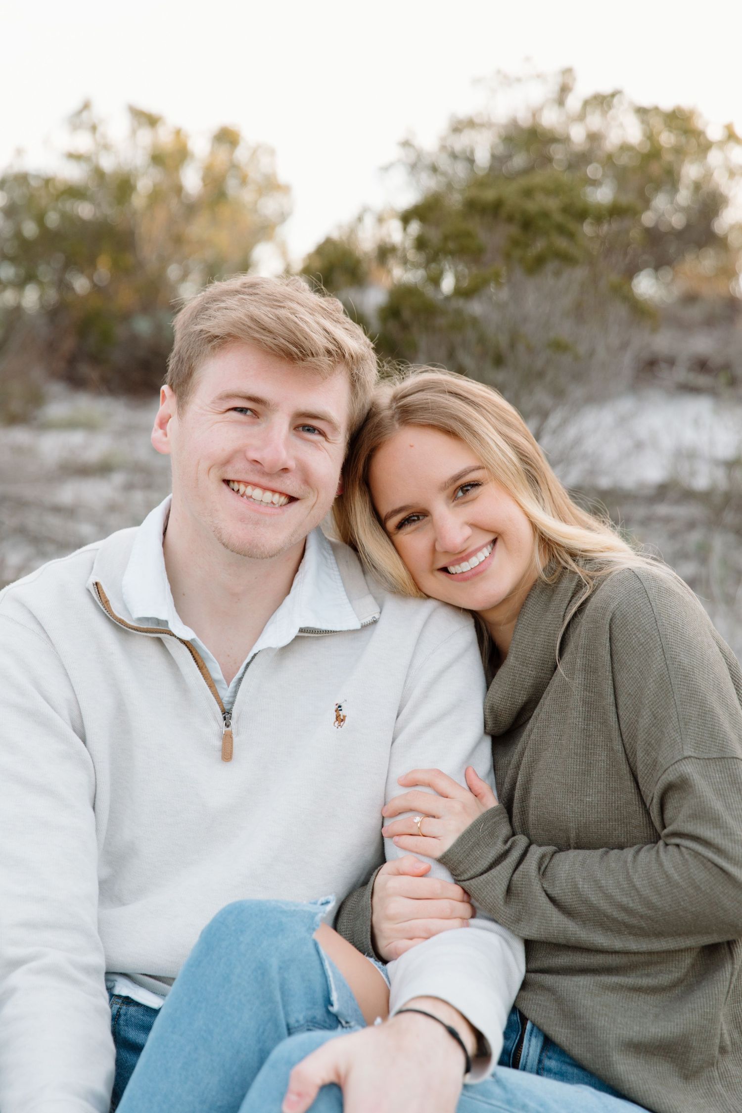 A couple sits together on a rocky surface wearing casual clothing and sharing intimate moments in a series of photos.