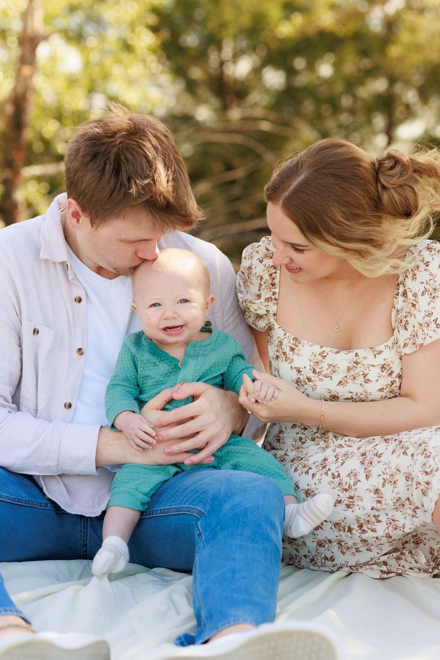 A series of intimate family portraits showing playful interactions on a white blanket outdoors.