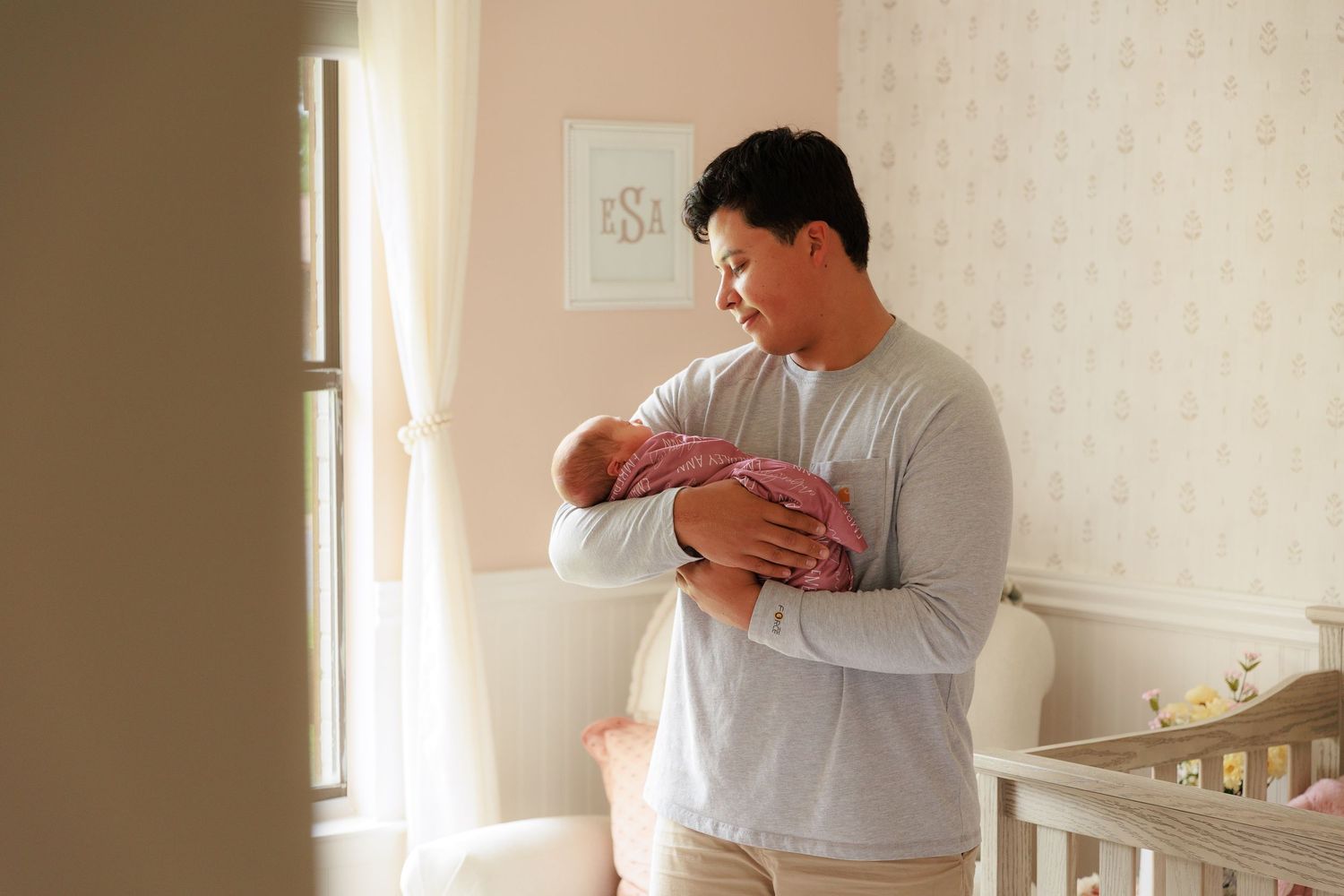 A series of seven connected images showing someone holding and comforting a crying baby in a sunlit room.