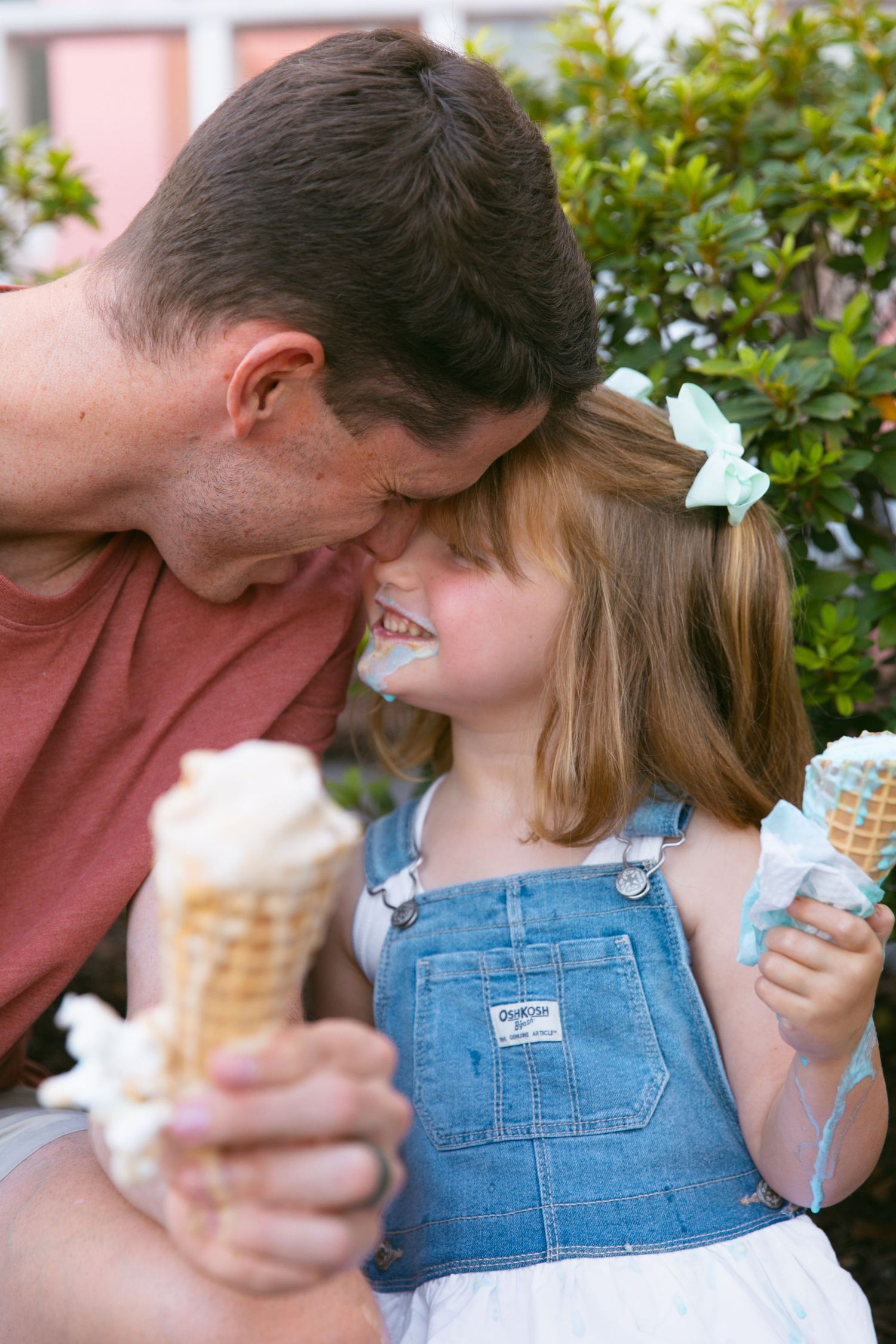 People enjoying ice cream cones together outside a vintage ice cream shop.