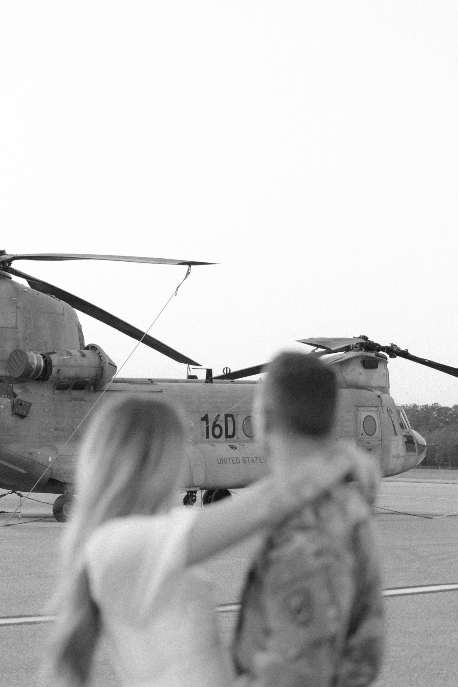 Black and white artistic photo of military helicopter on airfield.