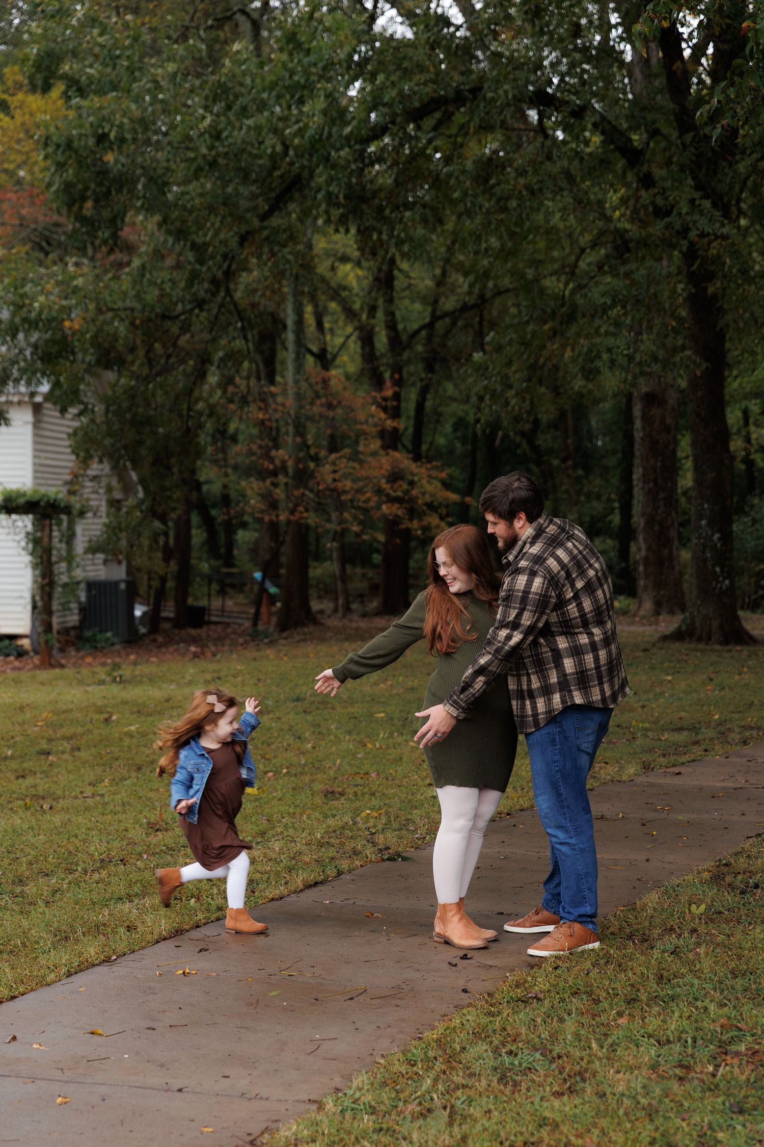 A sequence of four photos shows a playful interaction between people on a wooded path during autumn.