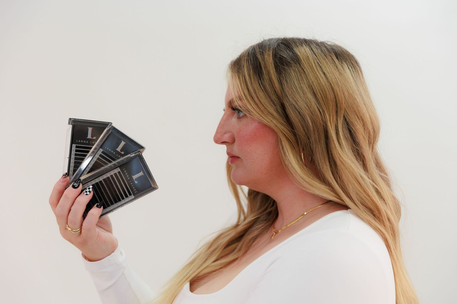 Side profile shot examining multiple dark cards against white background.