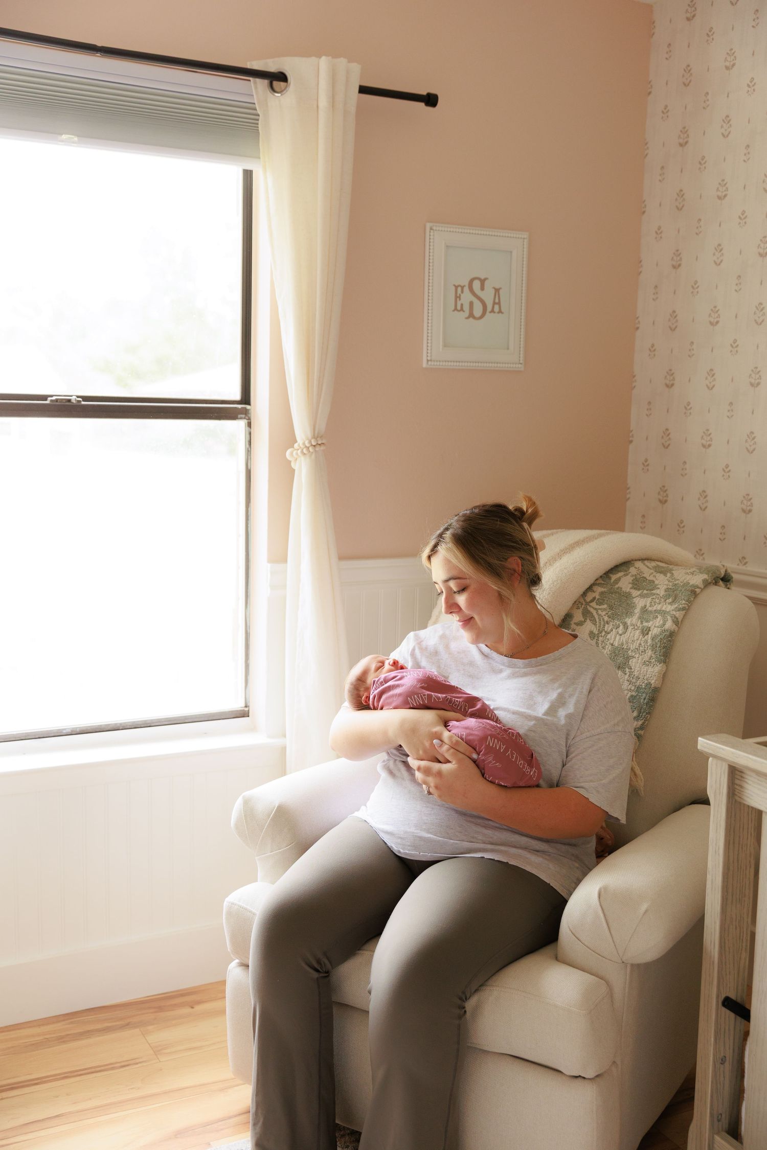 A series of photos showing a parent resting in a white armchair with a newborn baby in a bright, sunlit room.