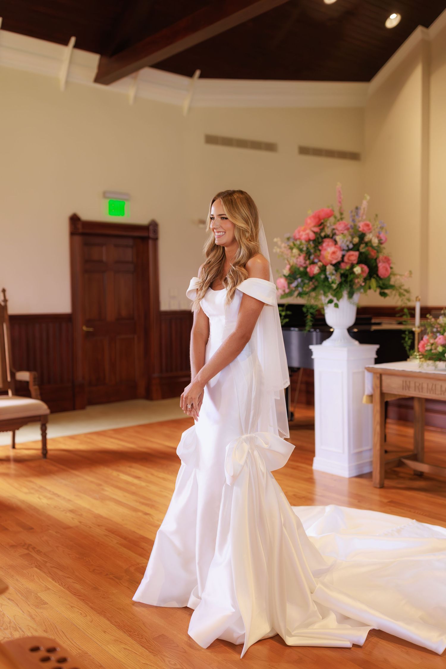 Five sequential photos show someone in a flowing white wedding dress spinning playfully on a hardwood floor at a venue.