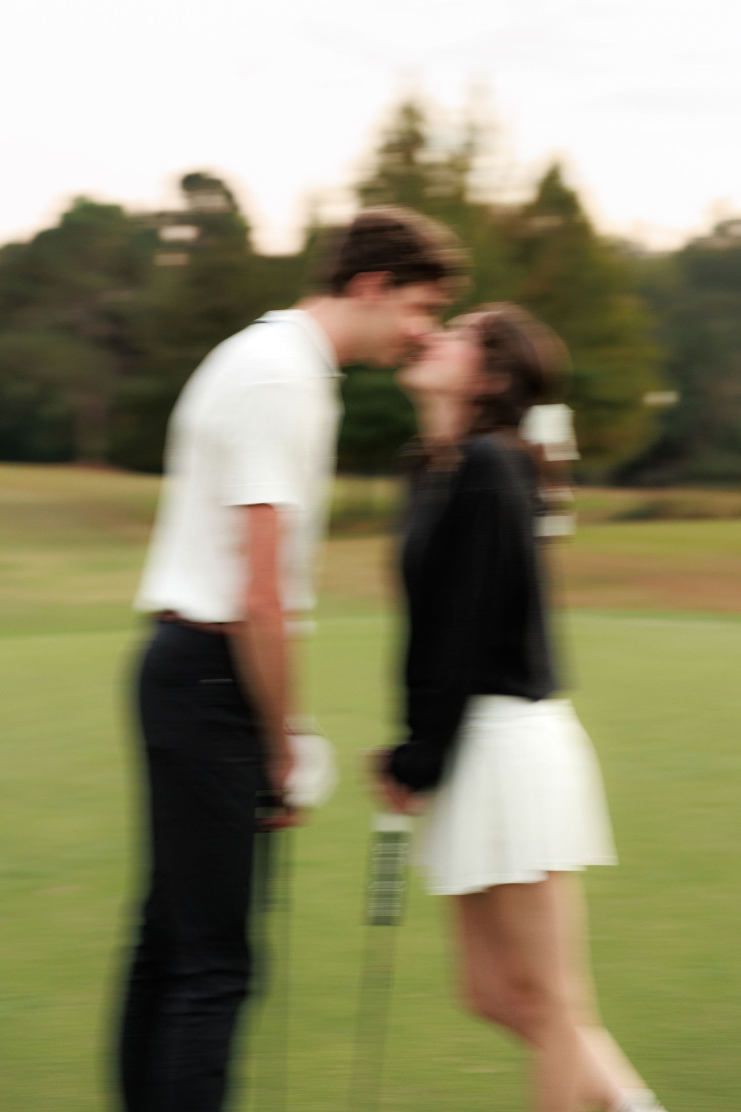 A sequence of five photos showing a couple dancing and spinning together on a grassy field at sunset.