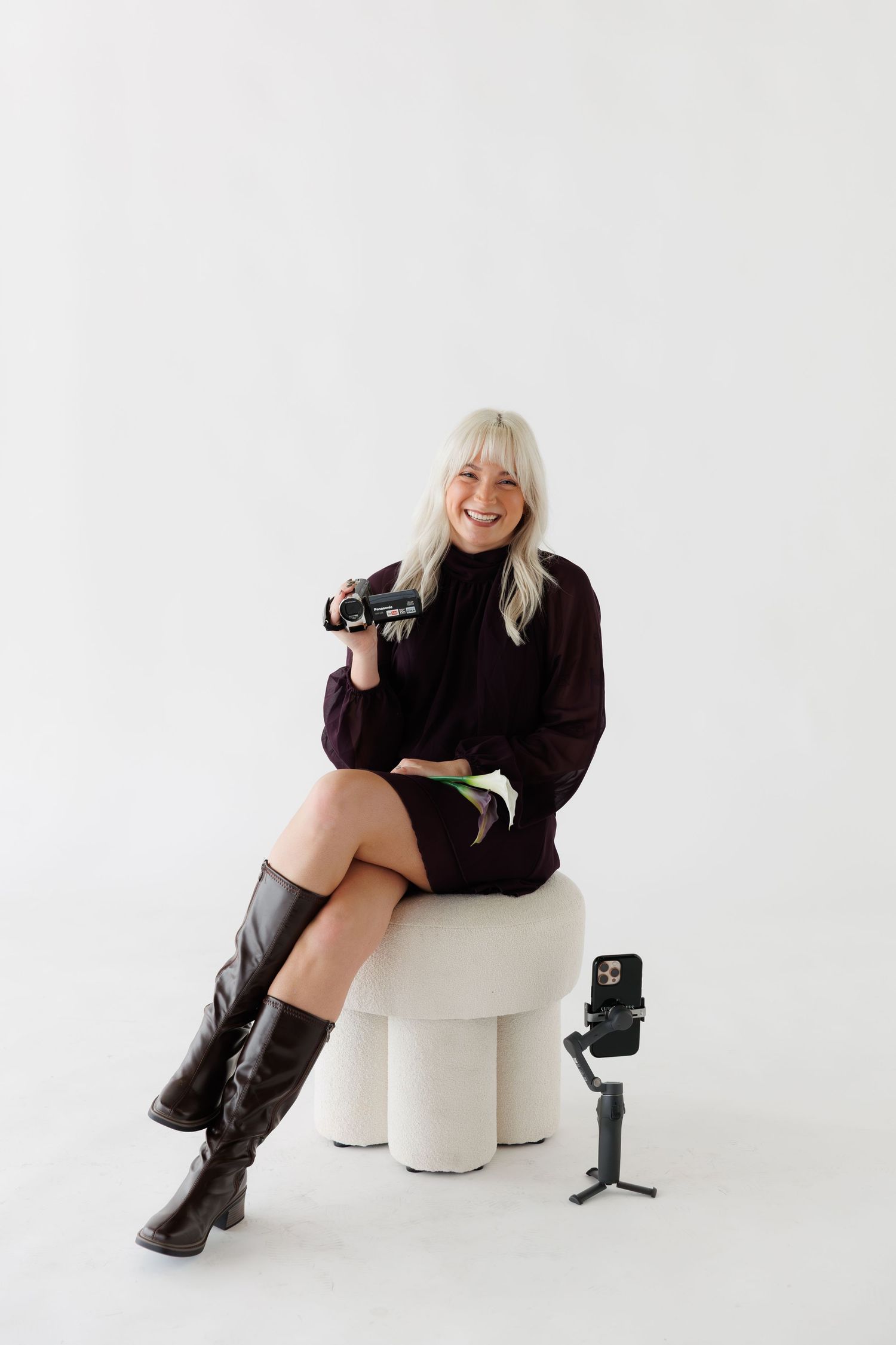 Behind-the-scenes content creation setup with camera equipment and white curved seating.