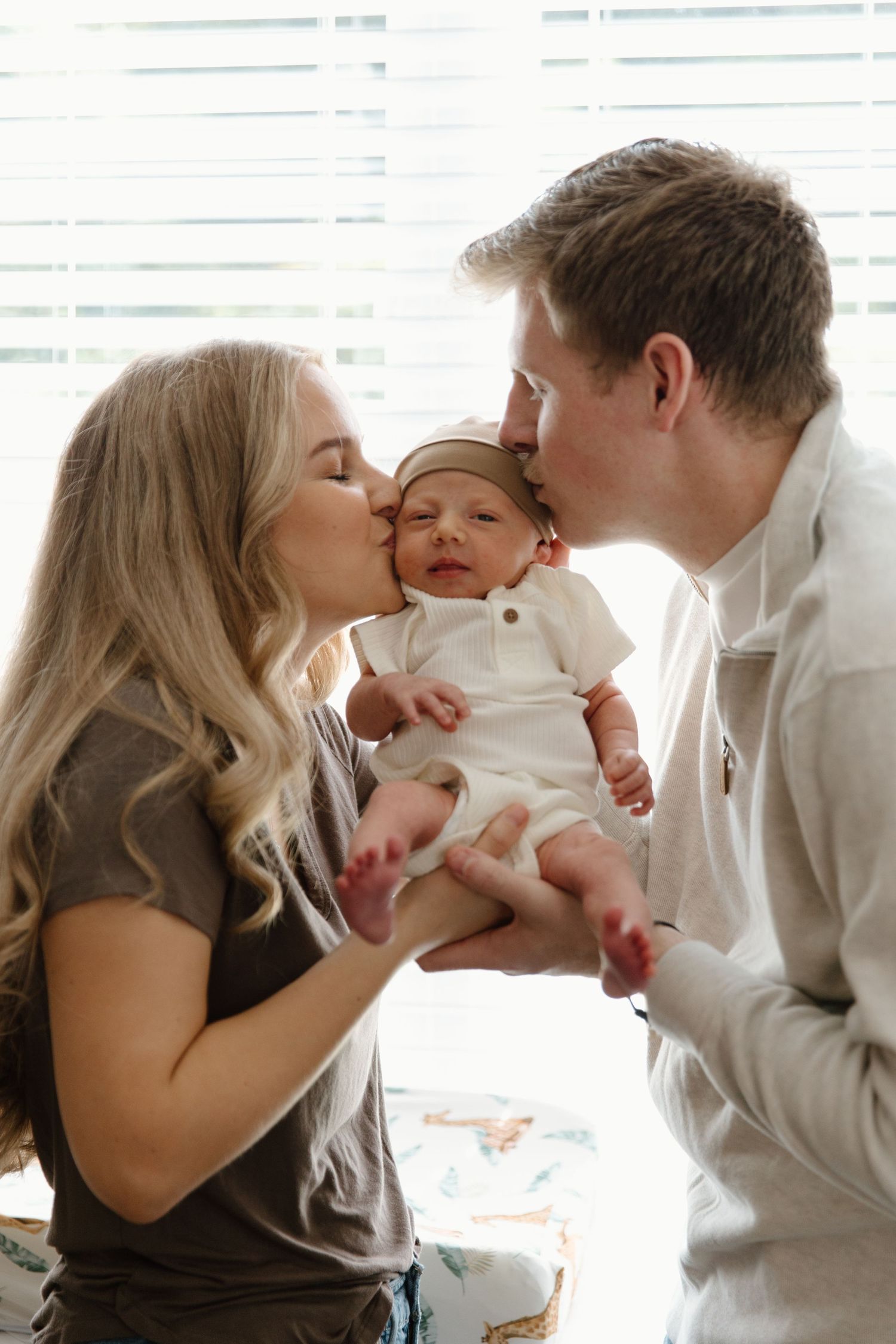 Loving parents share tender moments with their baby in a series of intimate close-up photographs.