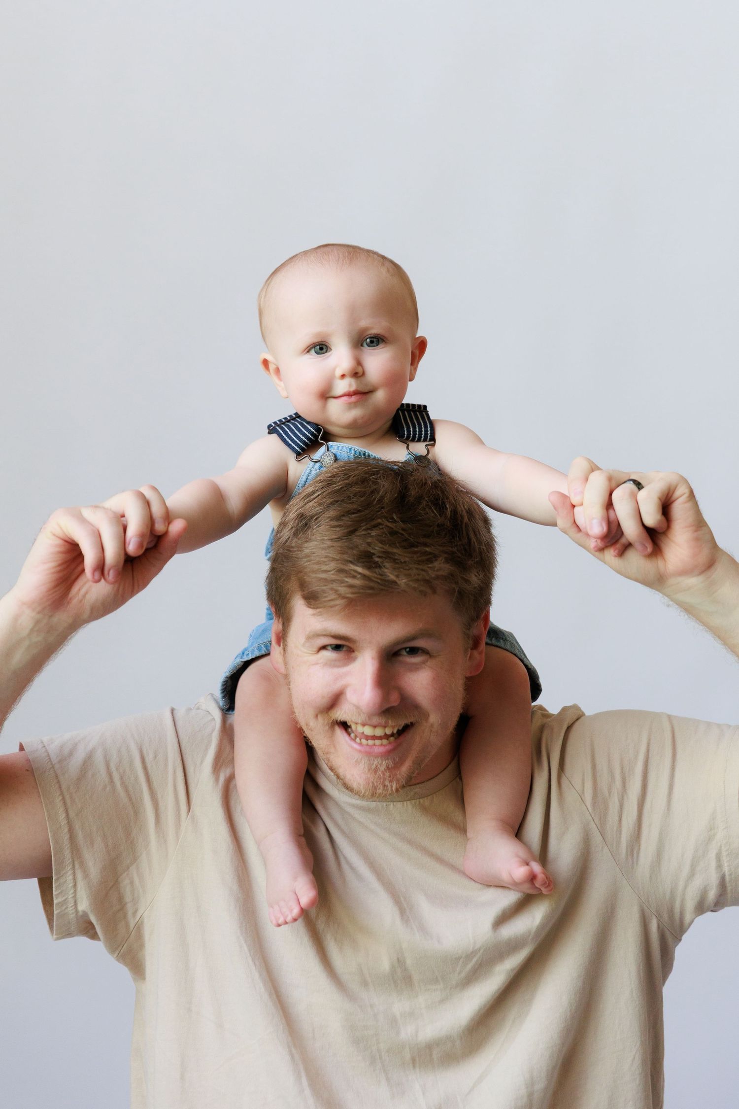 A creative photo sequence showing a baby being playfully balanced on someone's head in a beige shirt.