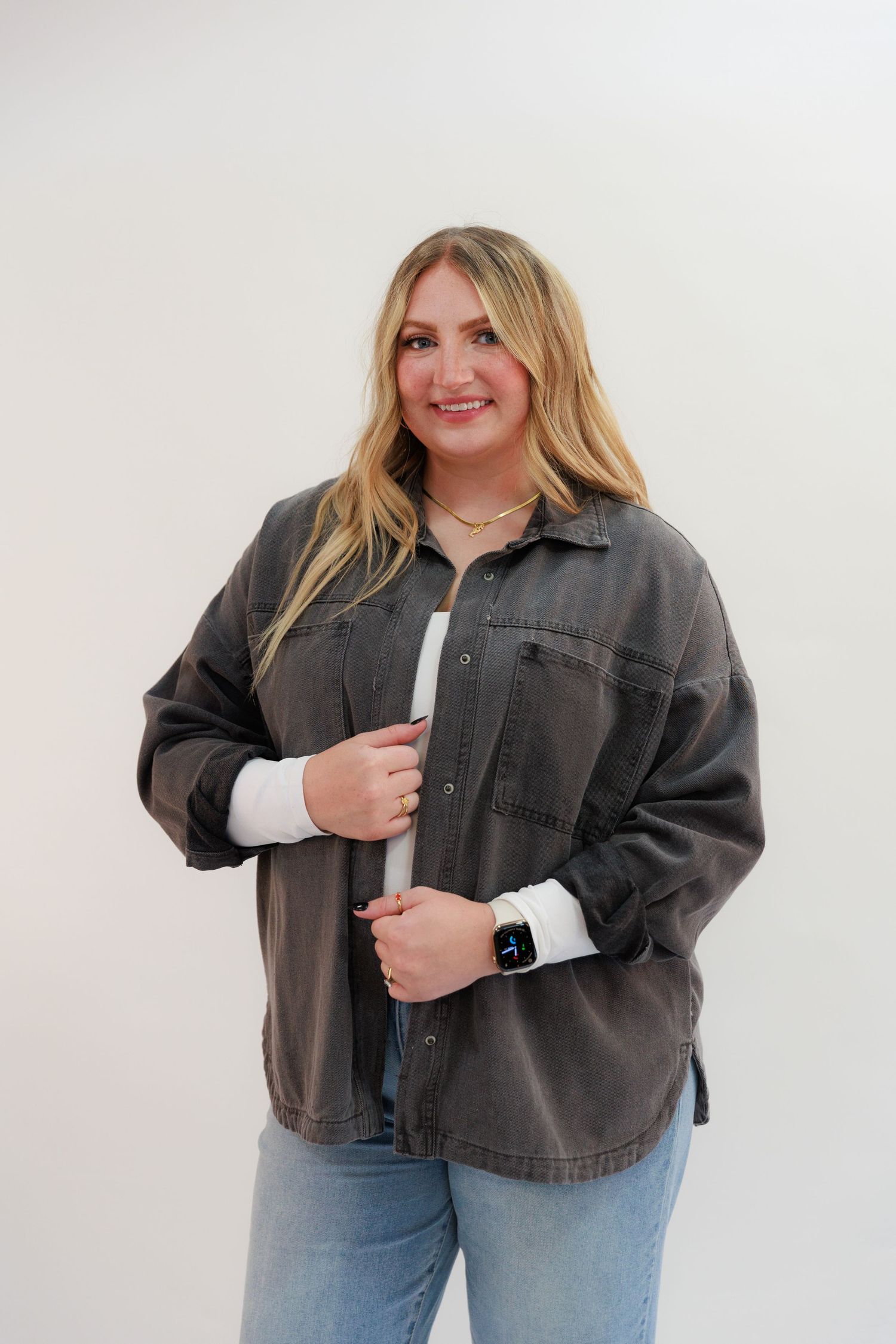 Stylish casual look with oversized gray jacket and white long sleeve top.