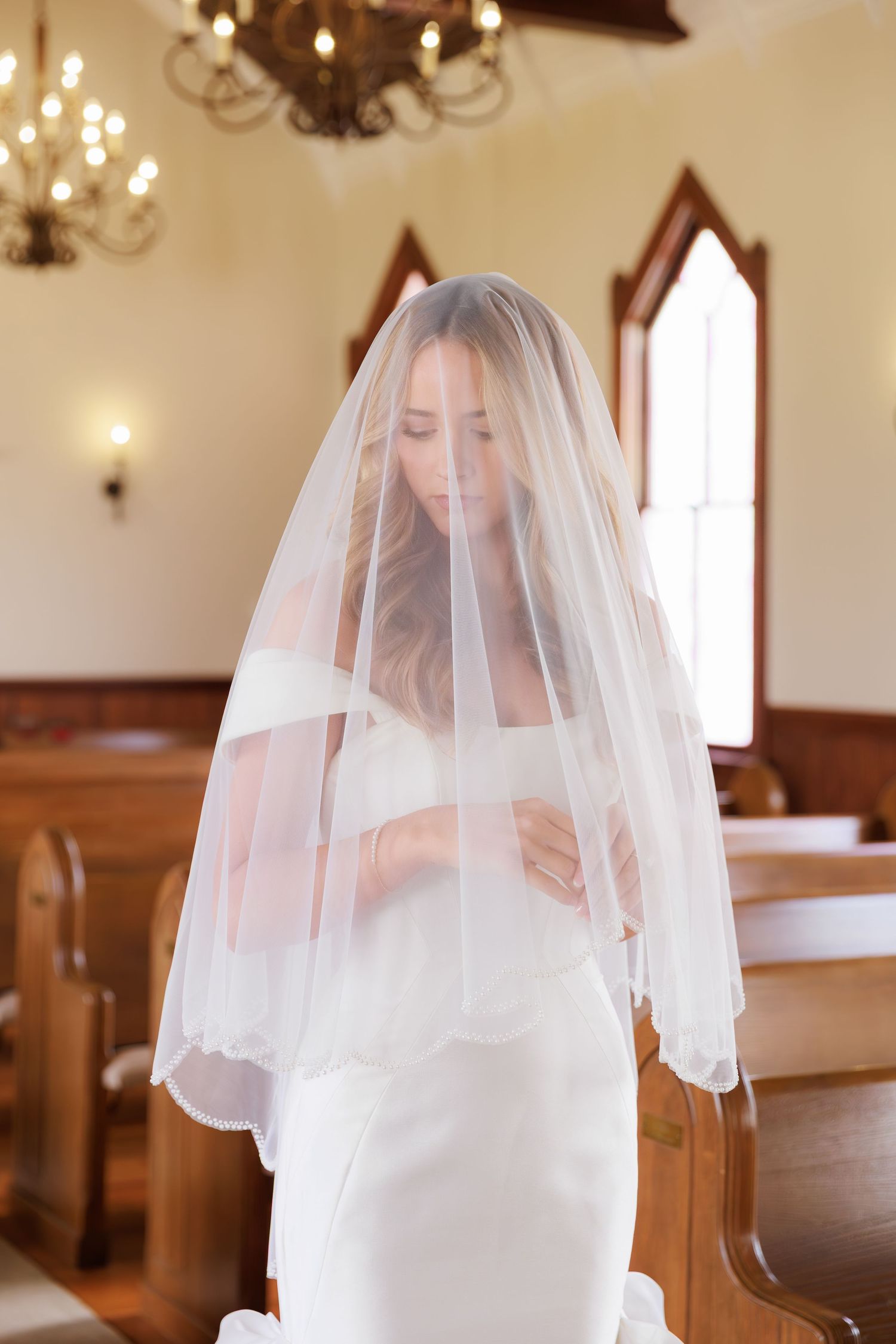 A sequence of bridal portraits showing a person in a white wedding dress and veil in an elegant church setting.