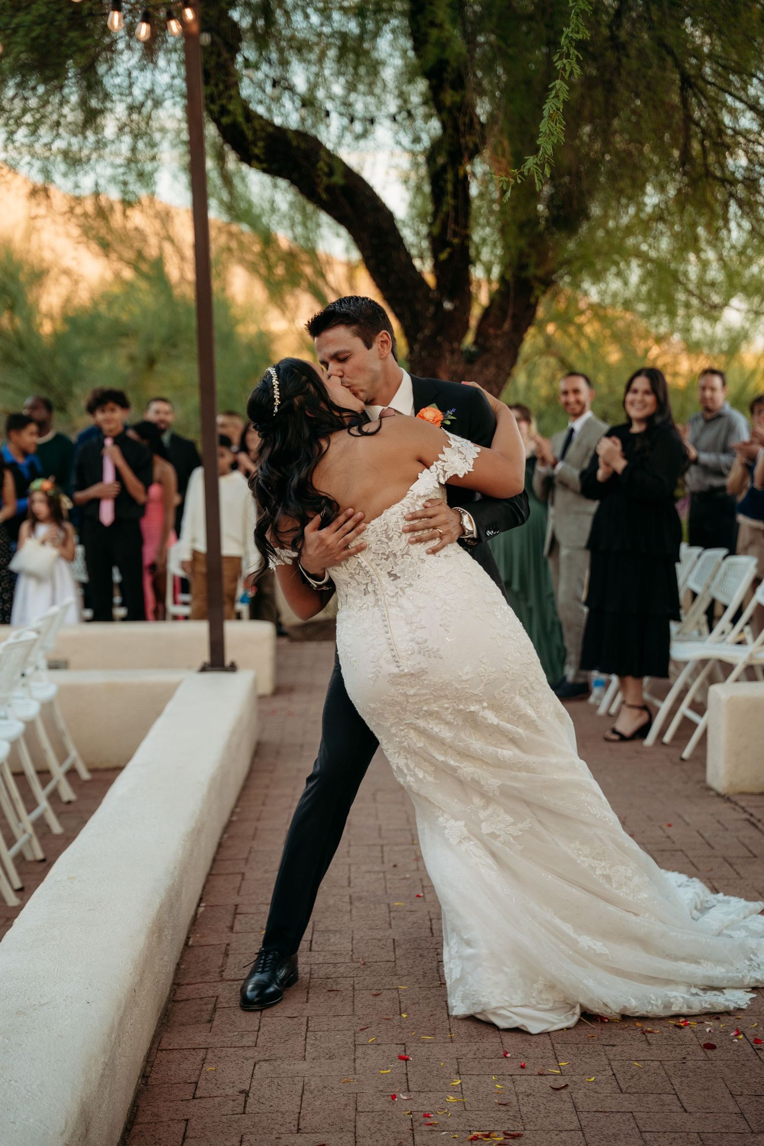 A romantic dip during a first dance at an outdoor wedding ceremony.