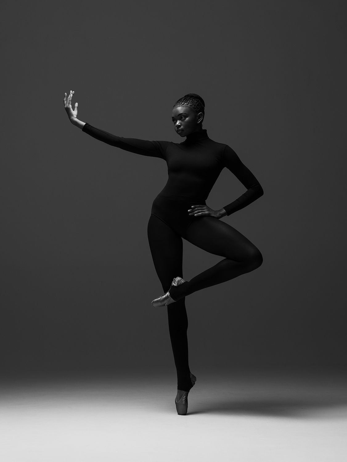 A dramatic series of black and white silhouettes showing a dancer performing graceful leaps and poses against a dark background.