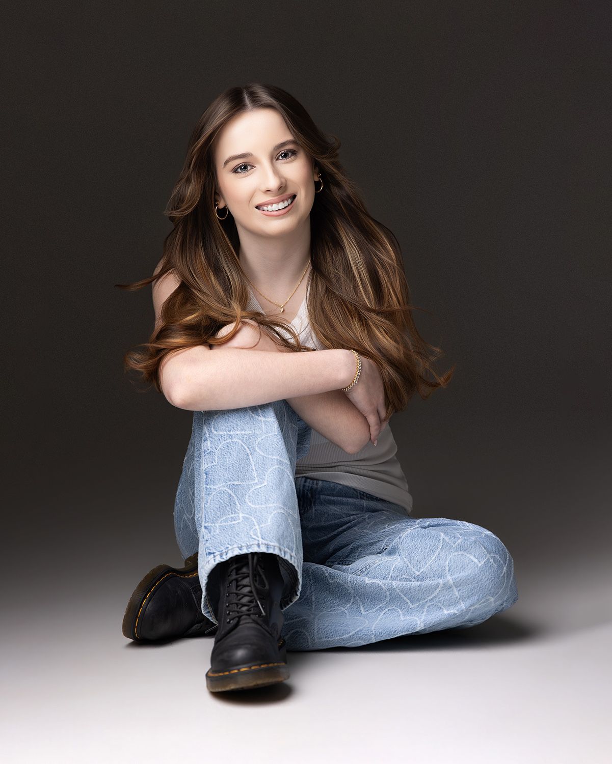 Atlanta high school senior photography of a teenage girl in jeans and white top at the Atlanta professional photography studio.