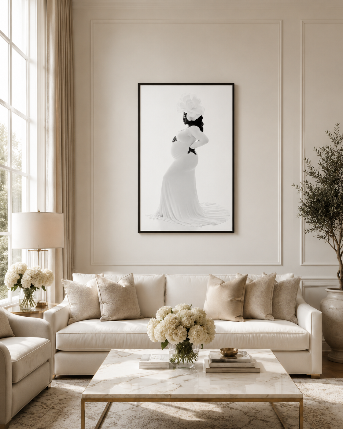 Elegant living room with cream sofa, marble coffee table, and framed black and white maternity art print on beige wall.