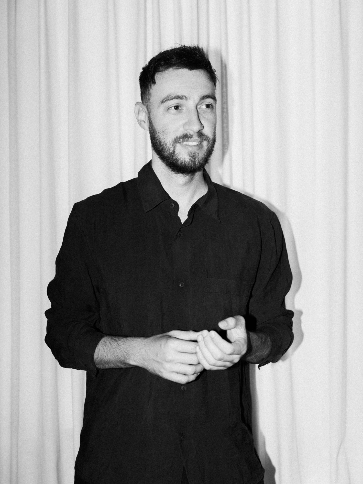 Photographer portrait (black and white) – A black-and-white portrait of a photographer holding a camera.