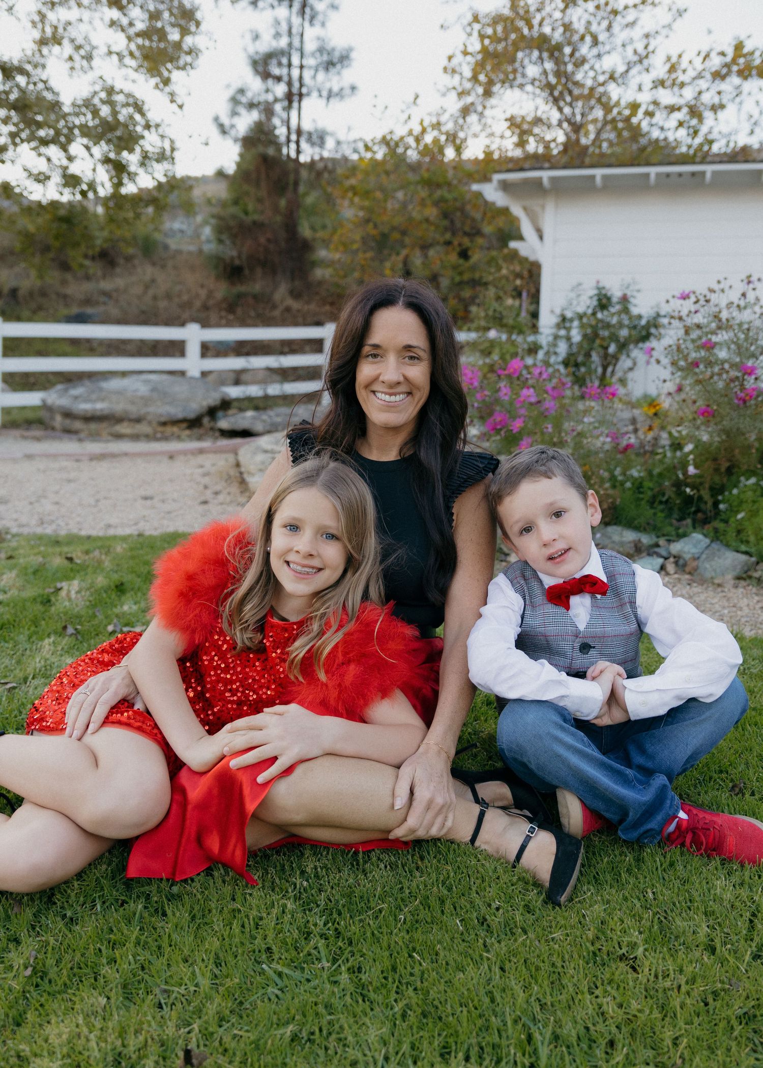 Family sitting smiling at the camera during a family photoshoot at the Madonna Inn in San Luis Obispo, California.
