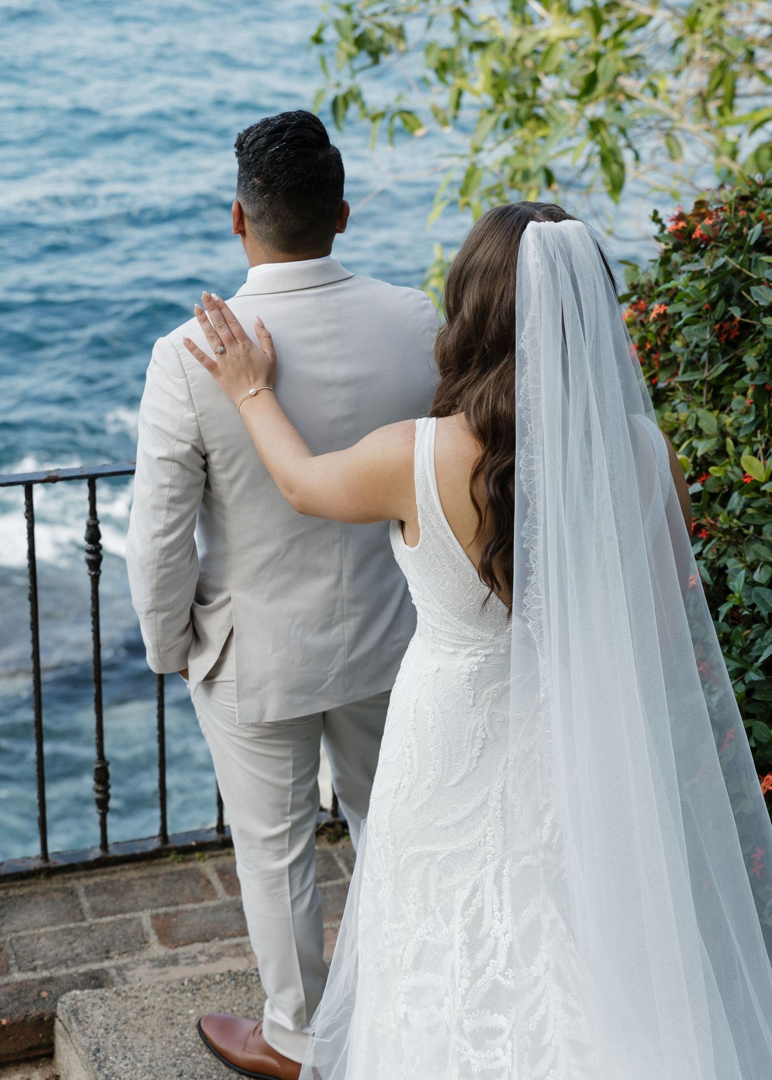 A bride and groom share their first look in Puerto Vallarta, Mexico with the ocean cliffside in the backdrop.