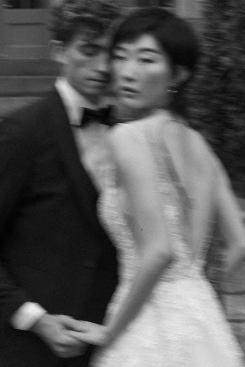 Artistic blurred black and white wedding portrait showing couple in formal attire.