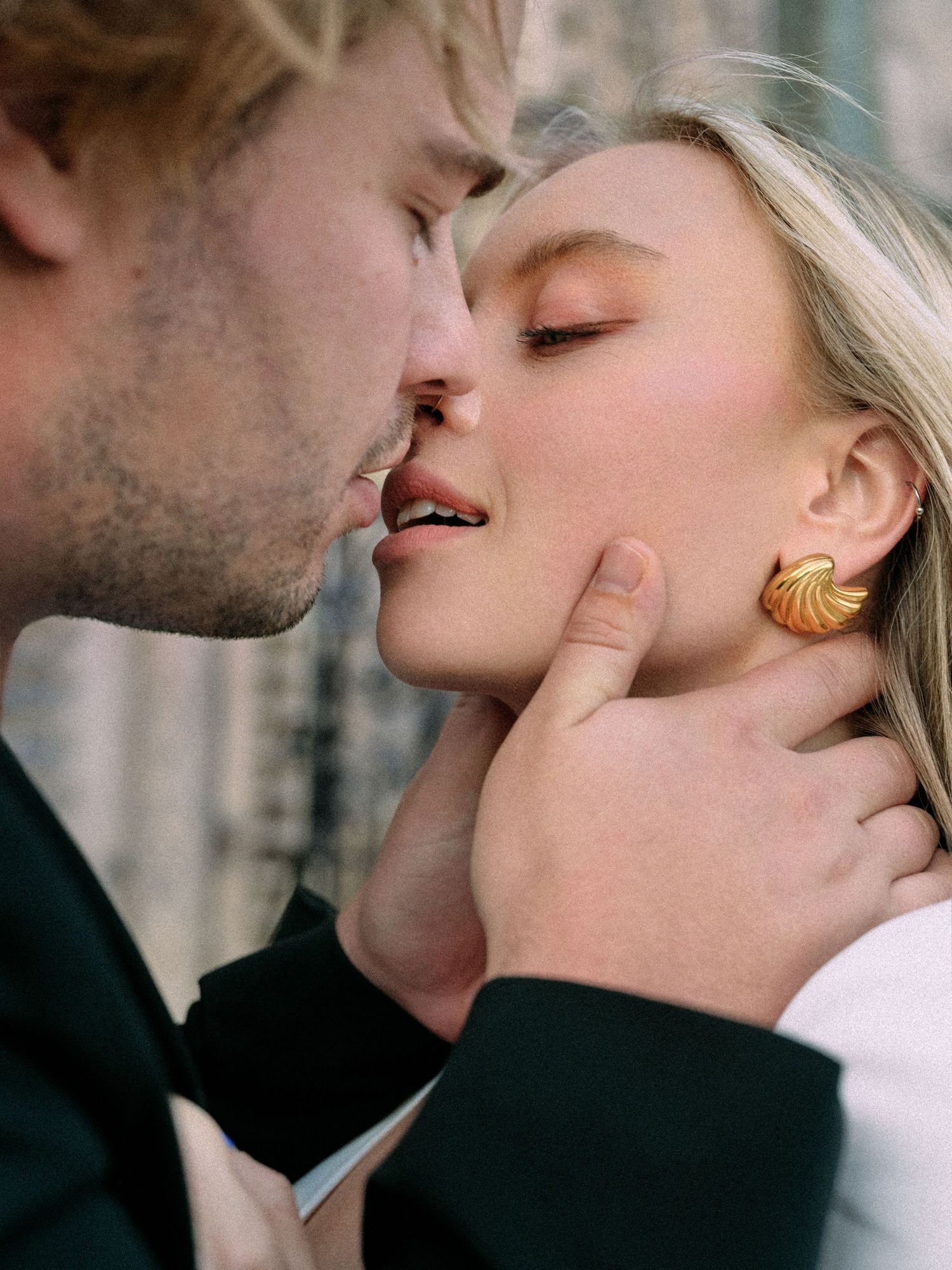 An intimate close-up portrait of a couple sharing a tender moment.