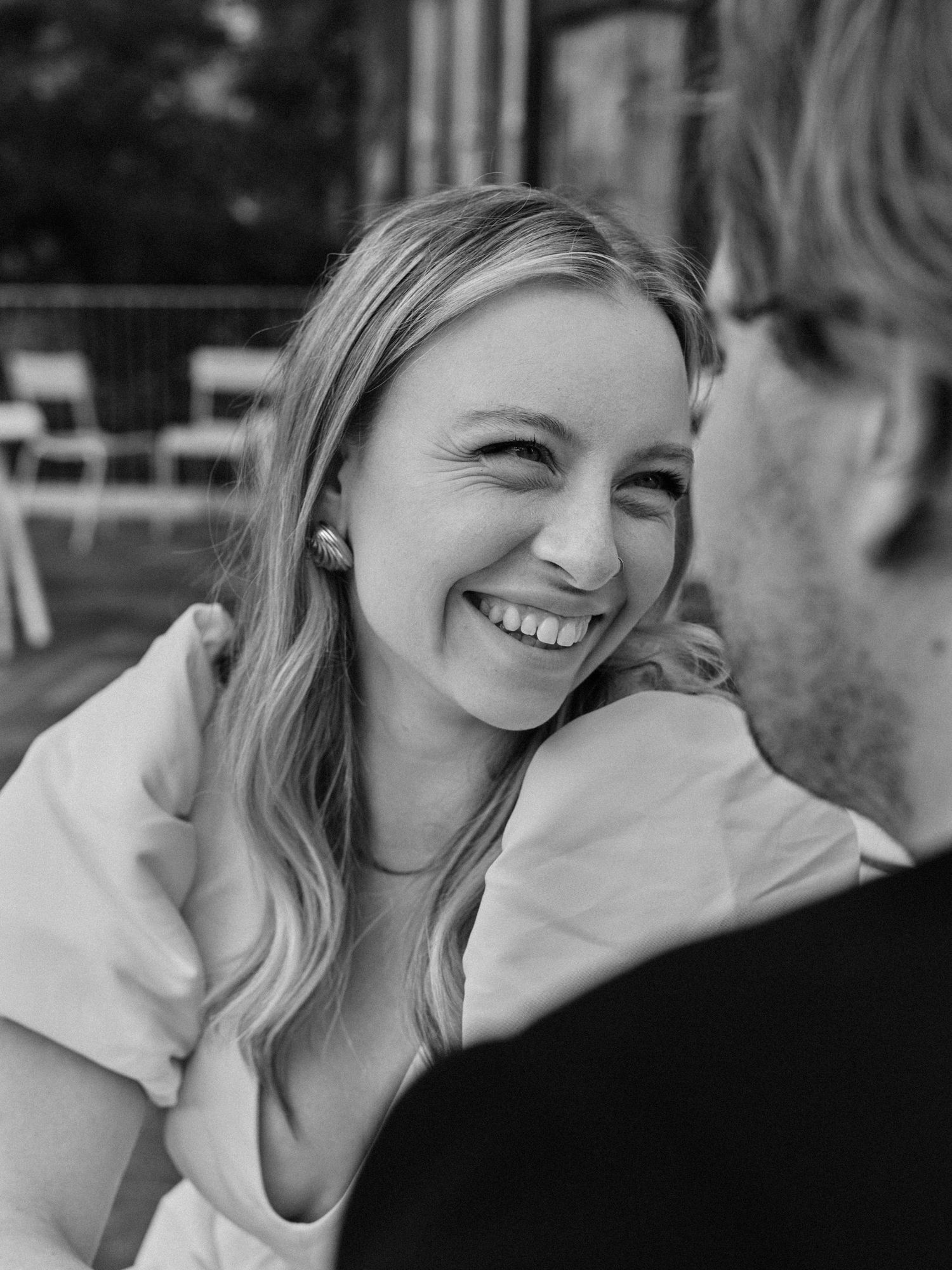 Black and white portrait of joyful moment between couple outdoors.