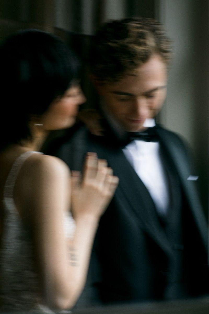 Artistic motion blur photo of couple in formal wear sharing an intimate moment.