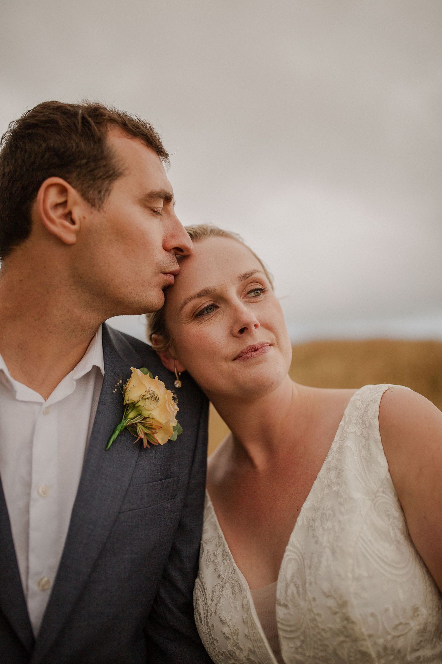 Wedding portrait photos, overcast. Bride and groom on farm.